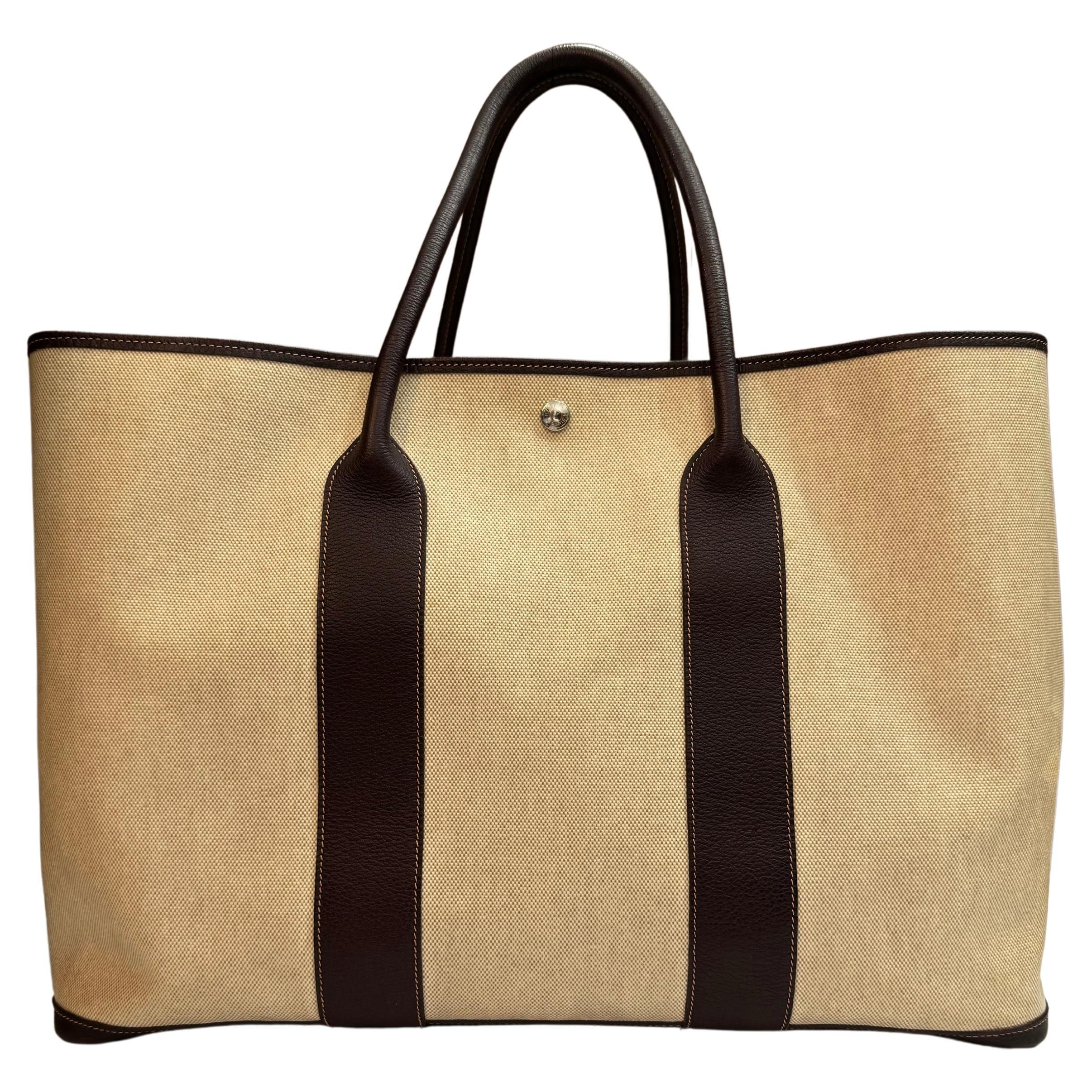 This HERMES Garden Party TGM tote bag is crafted of natural toile canvas trimmed with large-grained calfskin leather in marron brown and palladium hardware. Top wide opening with snap fastening opens to a spacious unlined interior. A rare extra