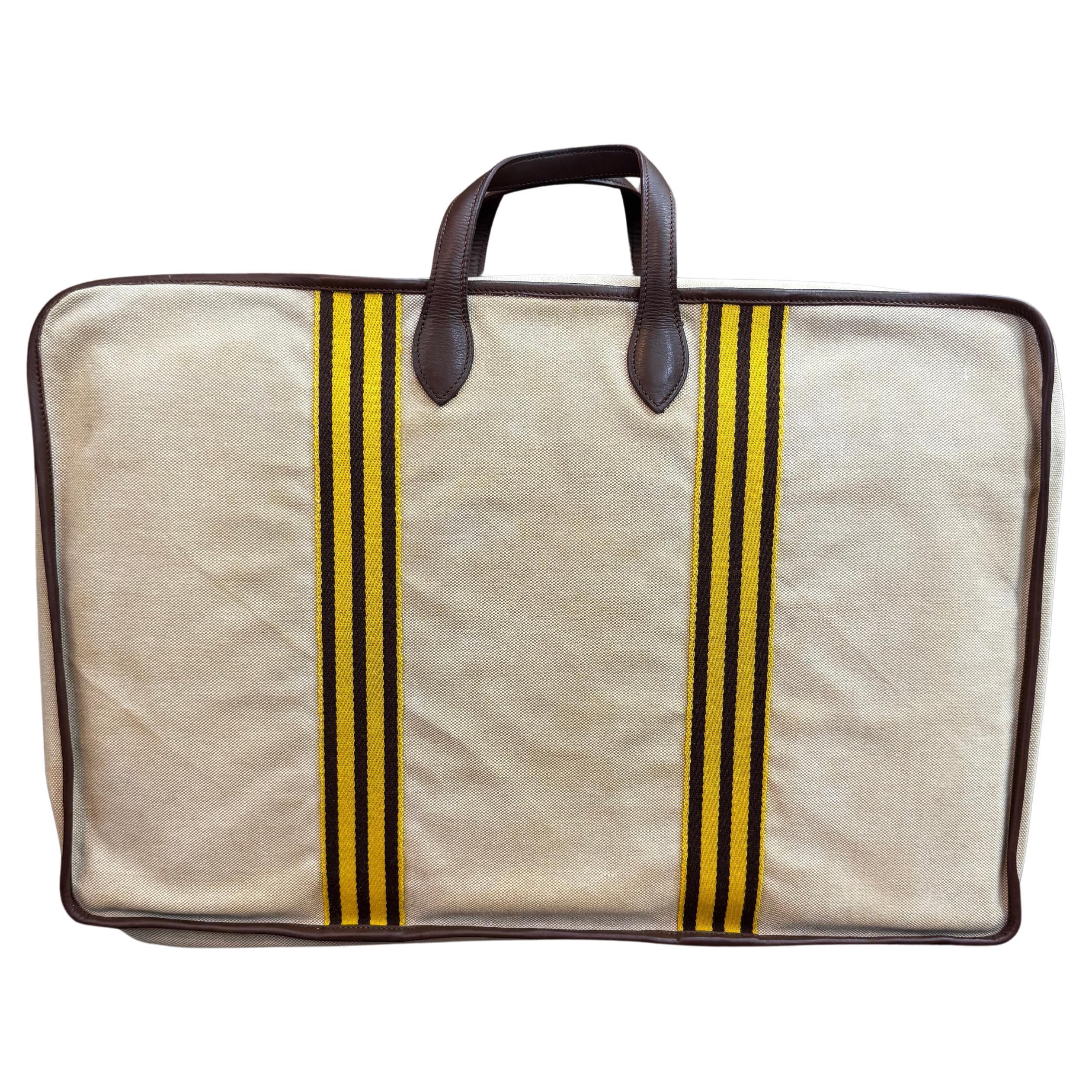Ce sac de voyage vintage HERMES Toile est réalisé en toile de coton beige clair et en cuir de veau lisse marron foncé. La fermeture à glissière ouvre sur un intérieur spacieux en coton doté d'un séparateur de rangement amovible dans la même matière.