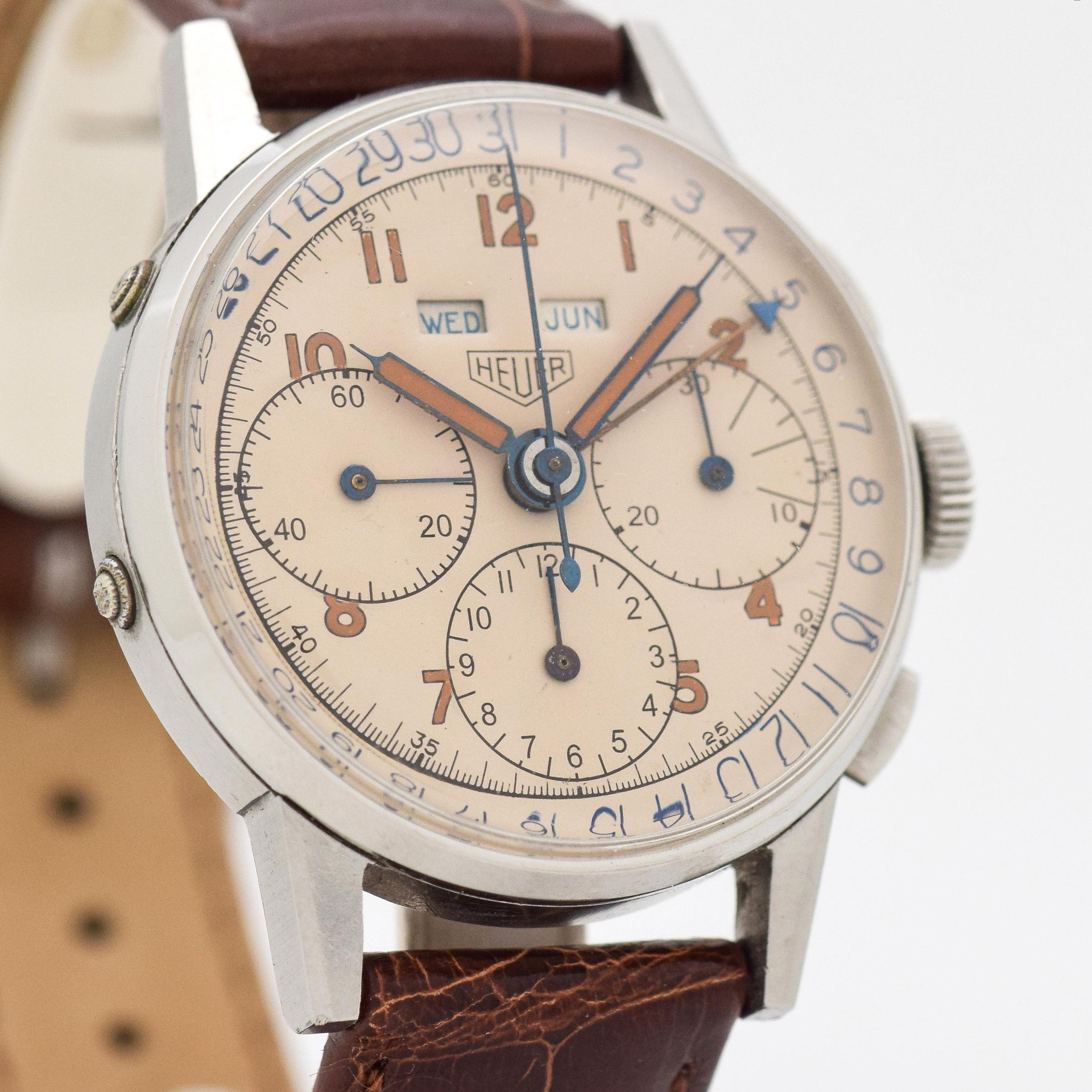 1940's Vintage Heuer Triple Date Chronograph Watch. Stainless Steel case. Original, but restored silver dial with Arabic numerals. Powered by a 17-jewel, Valjoux 72-C movement. 35mm x 43mm lug to lug (1.38 in. x 1.69 in.) - Equipped with a Glossy,