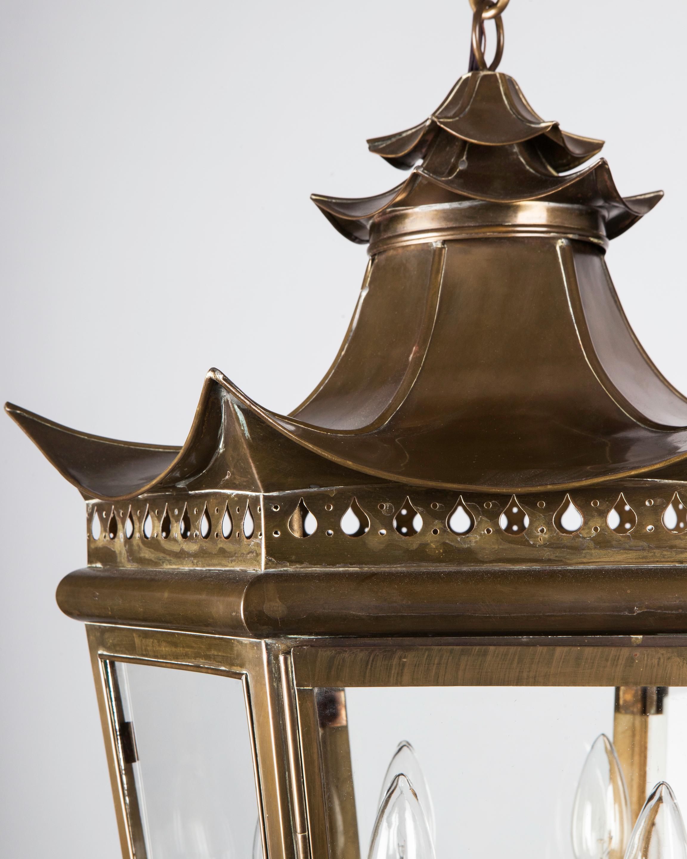 AHL4189

A large vintage brass lantern with a swept-up pagoda form body in its original age-darkened finish. The tapered hexagon frame has pierced details above and below, including a teardrop frieze and the motif of curved panels meeting in
