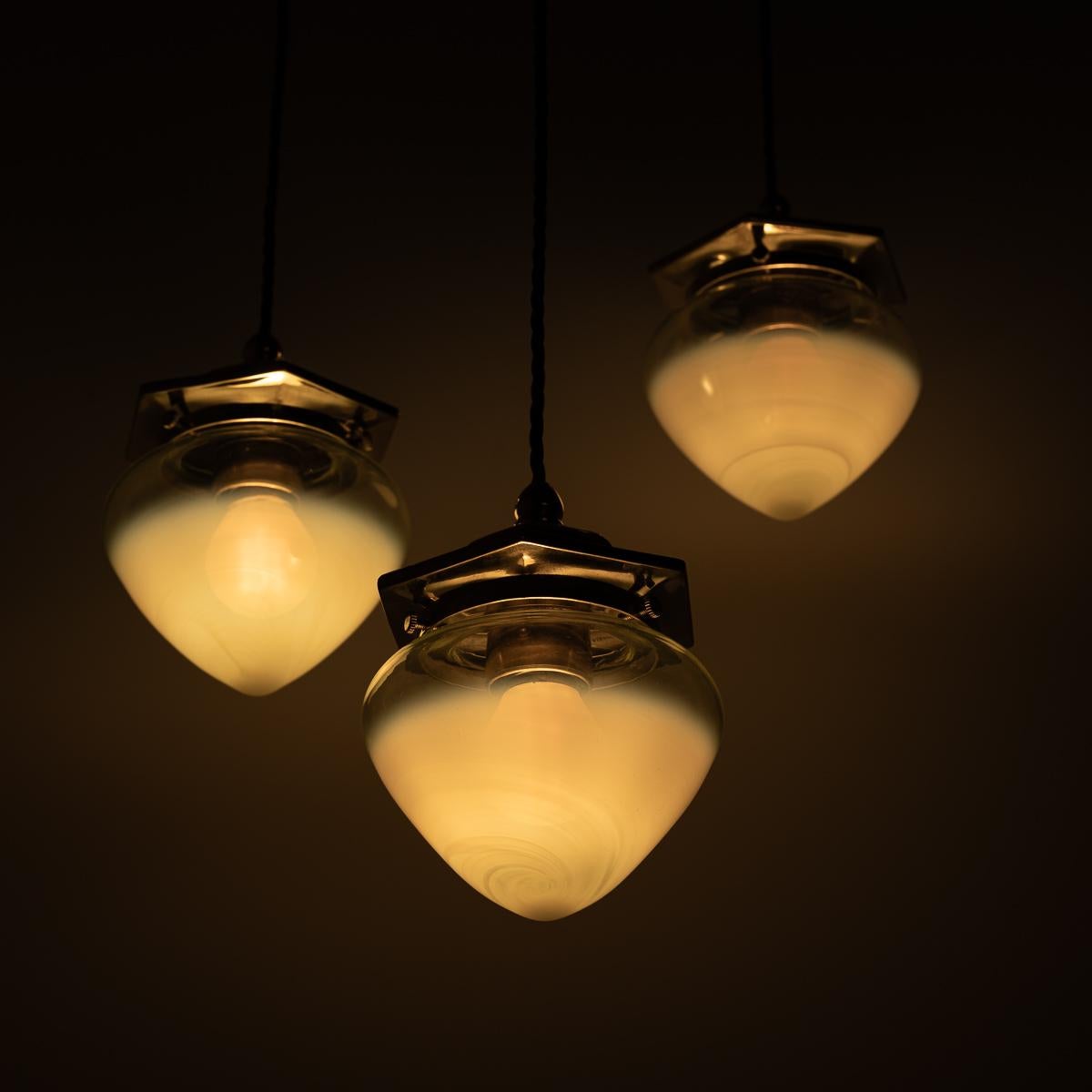 Beautiful Trio of Petite Pendant Lights with Vaseline Glass Shades
SOLD AS A SET OF THREE

A stunning set of petite pendant lights with brass hexagonal fittings and hand crafted vaseline glass shades.

The matching hexagonal ceiling and gallery