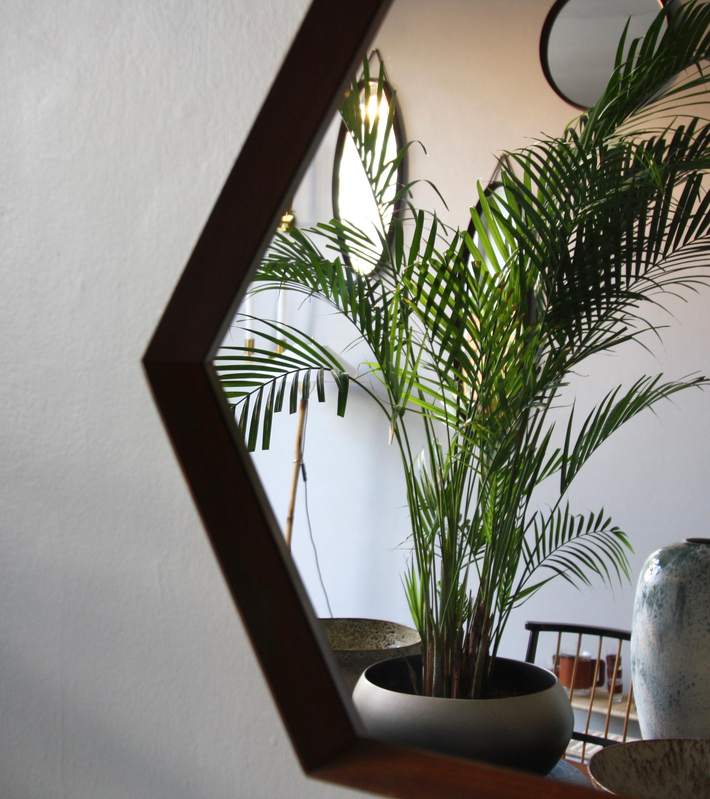 A vintage hexagonal wall mirror with string hanging strap, made in Denmark, circa 1950. The mirror is made of sections of solid teak wood which are joined together using finger joints. This exposed construction, the rope strap and the tapering of