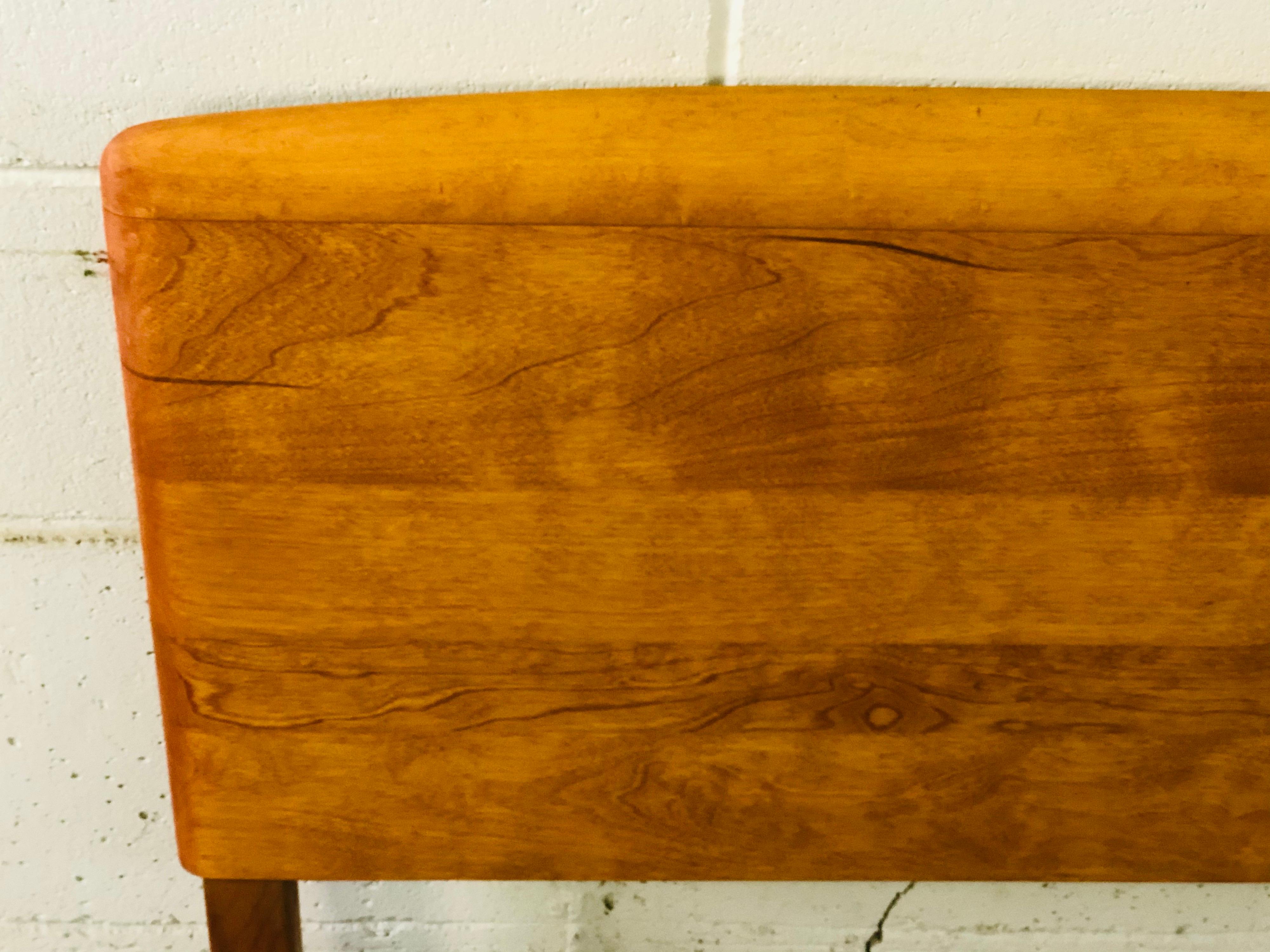 Vintage Heywood-Wakefield maple wood queen size headbaord with a curved top design. The rail slots are 55” apart. The headboard is newly refinished and marked.