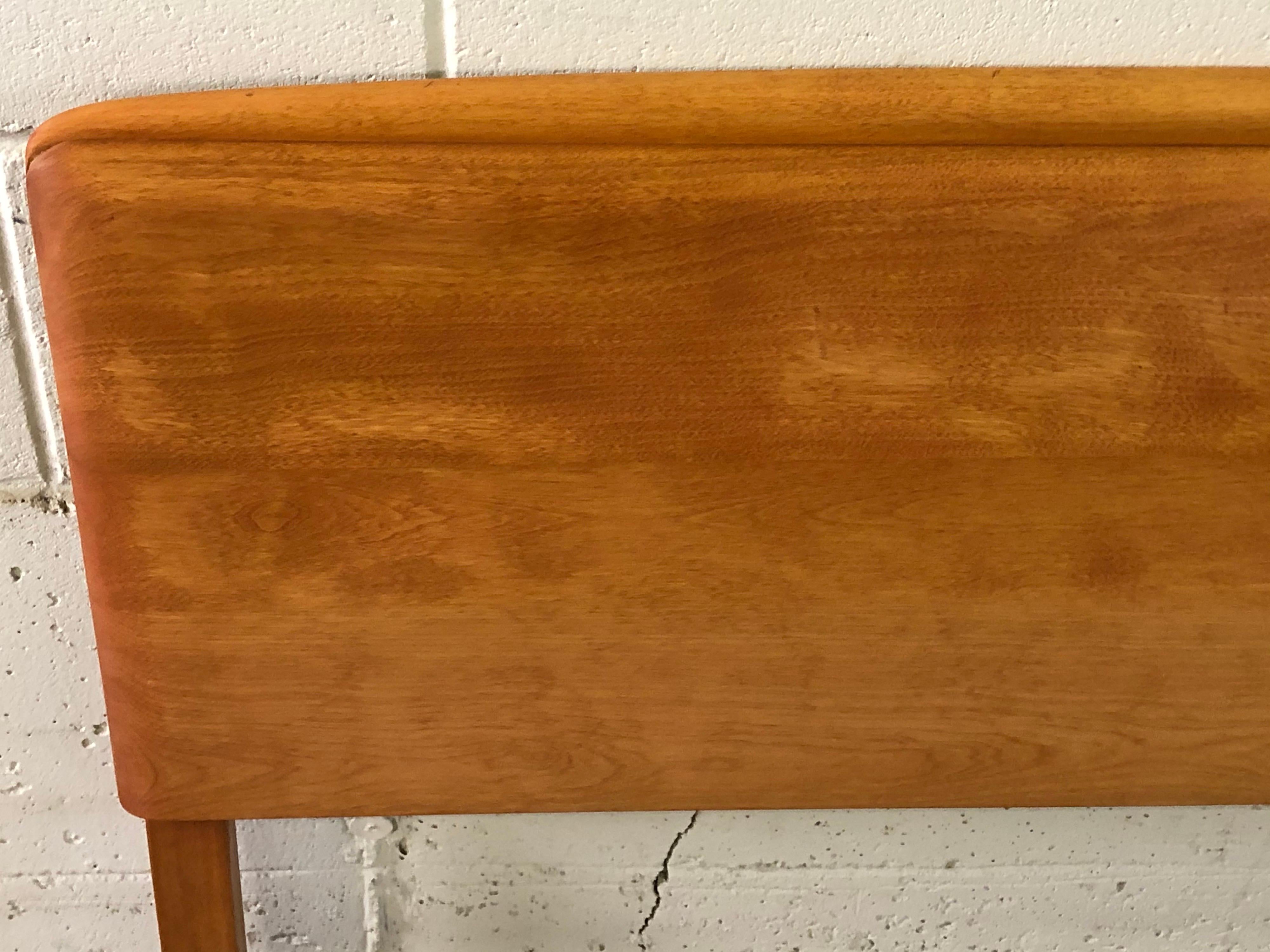 Vintage Heywood-Wakefield maple wood queen size headboard. The rails slots are 55” apart. The headboard is newly refinished and marked.