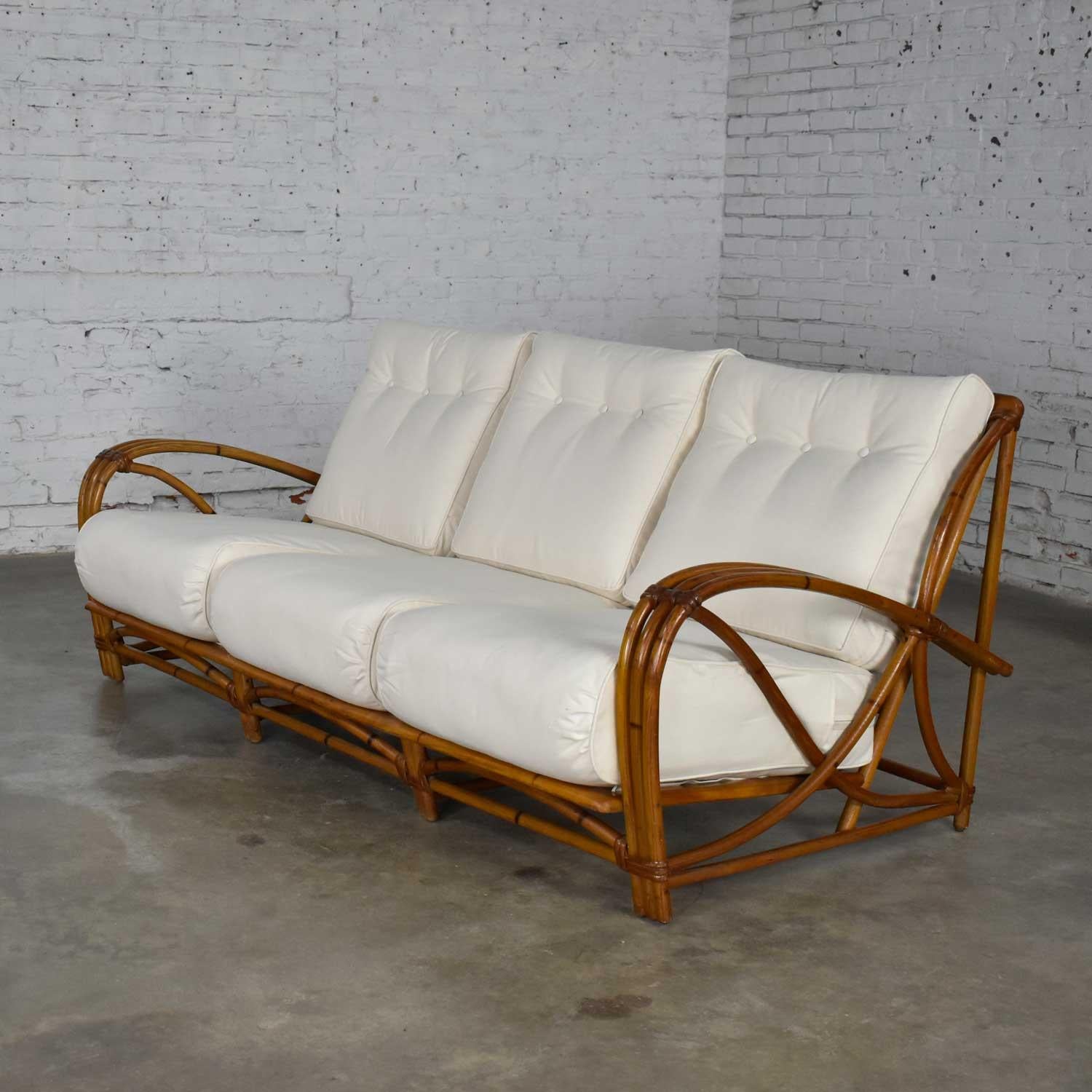 Wonderful vintage Heywood Wakefield rattan sofa with new off-white canvas upholstery. We will be including the original barkcloth zip-off covers as well. Beautiful condition with wear as you would expect with a vintage piece. There has been some
