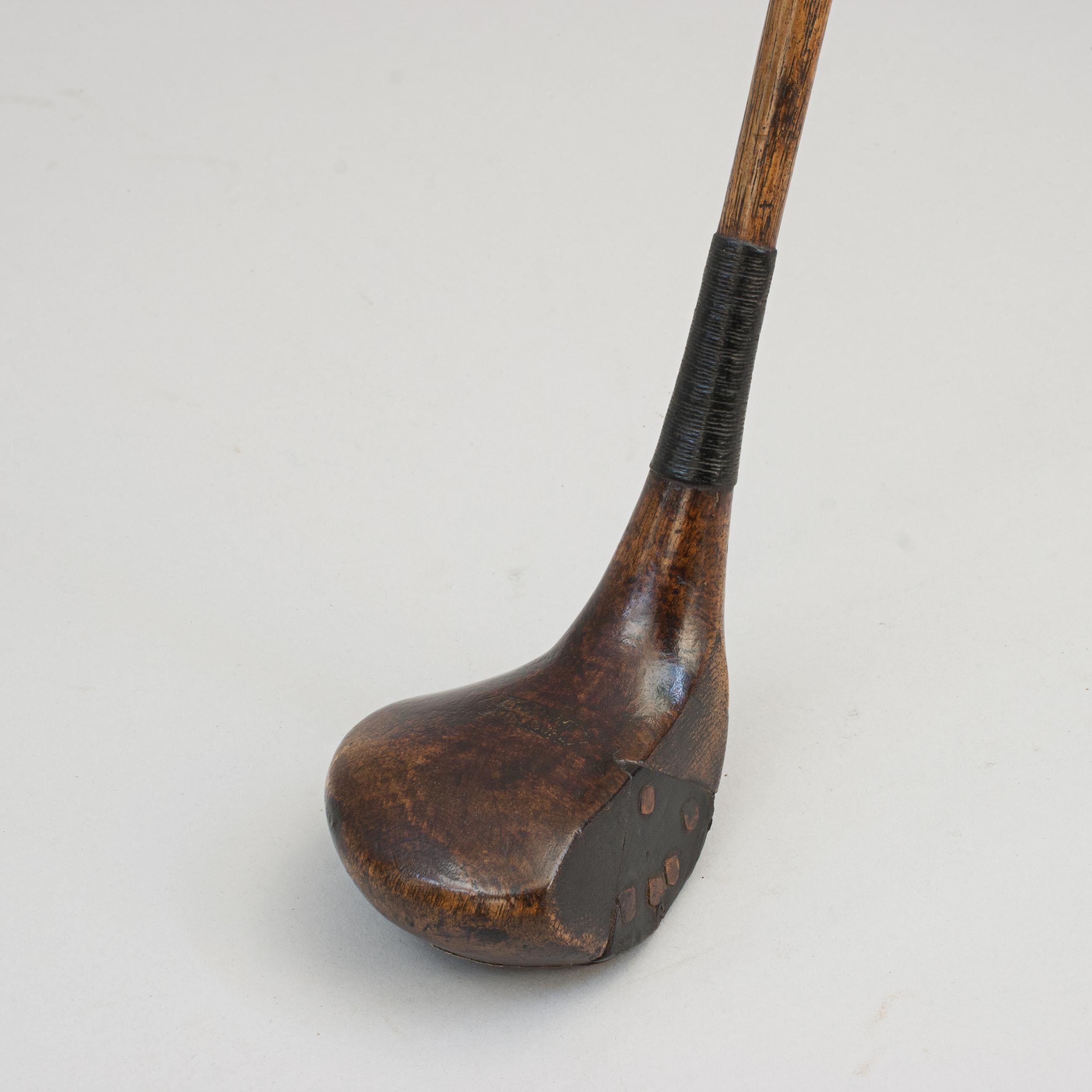 Antique Golf Club, Brassie (Fairway Wood).
Persimmon head socket head brassie/spoon with hickory shaft and a leather grip. The head is possibly stamped 'Jersy Hill, Harrogate', face with insert fitted with wooden pegs, a full brass sole plate