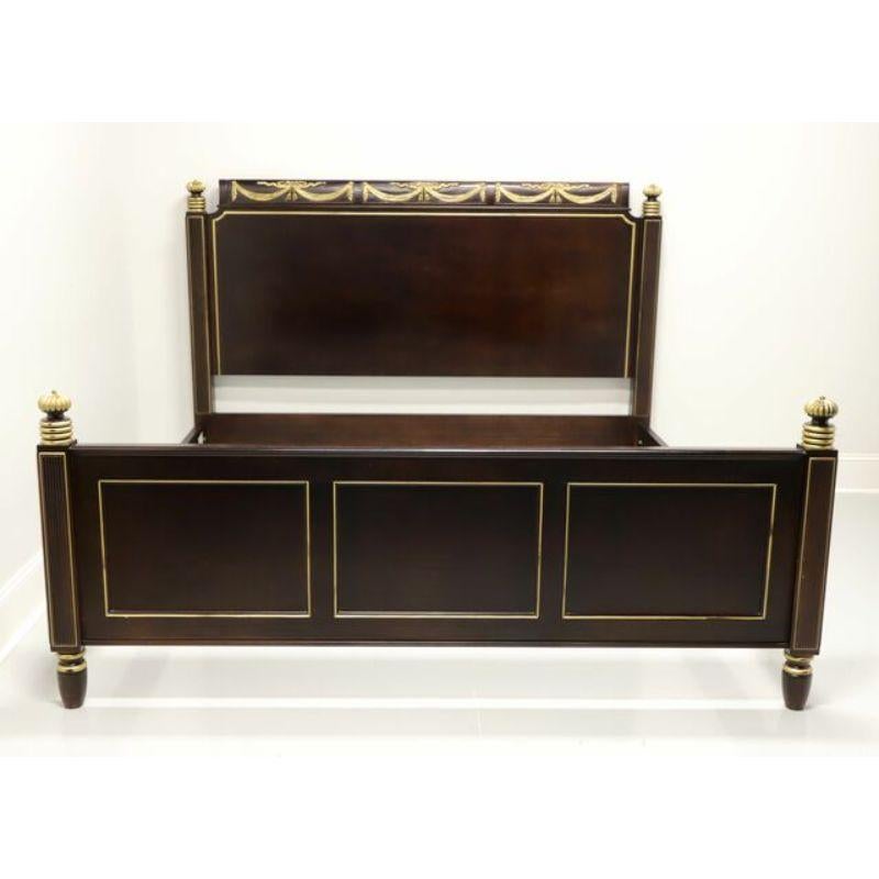 An English Regency style king size bed by Hickory Chair. Espresso brown stained hardwood with gold painted accents. Features carved crest with ribbons, tassels and drapery, fluted finials and moldings, bolt held side rails, and turned legs. No