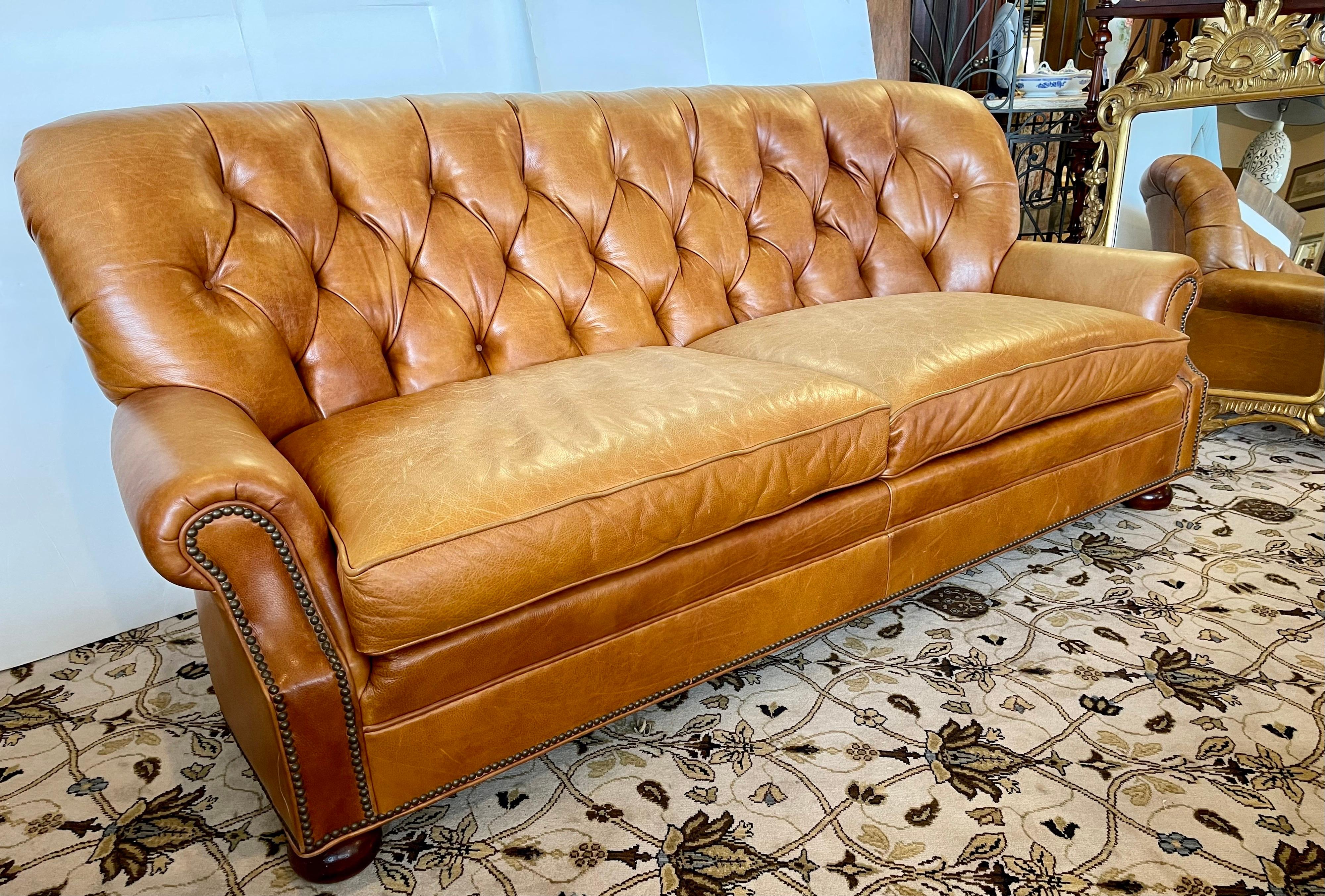 Stunning signed Hickory Chair Company Chesterfield sofa. Note we have the matching chair and ottoman combo also exclusively on 1stDibs this week as well. The pebbled caramel color leather has been broken in just right and there is some fading on the