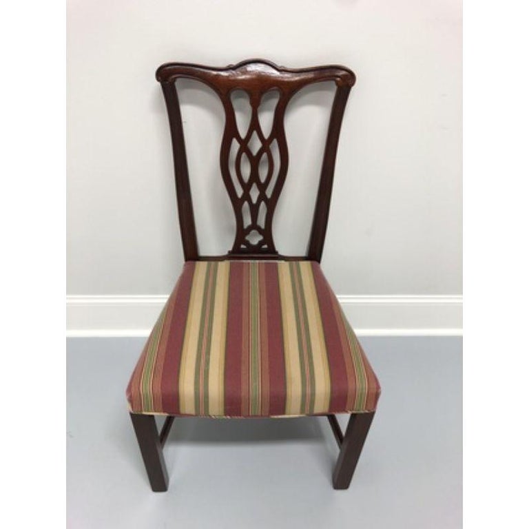 A mahogany dining side chair in the Chippendale style. Made in the USA by Hickory Chair Company in the early 1990s (labels missing). Solid mahogany with straight legs and stretcher bases.

Measures: Overall: 21.5 W 23 D 38.5 H, Seats: 21.5 W 17 D 19