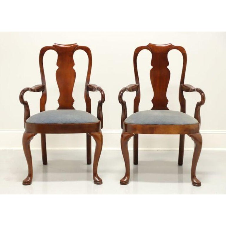 A pair of Queen Anne style dining side chairs by top quality furniture maker Hickory Chair Company. Solid mahogany with carved backs, blue patterned fabric upholstered seats, cabriole legs and pad feet. Made in North Carolina, USA, in the late 20th