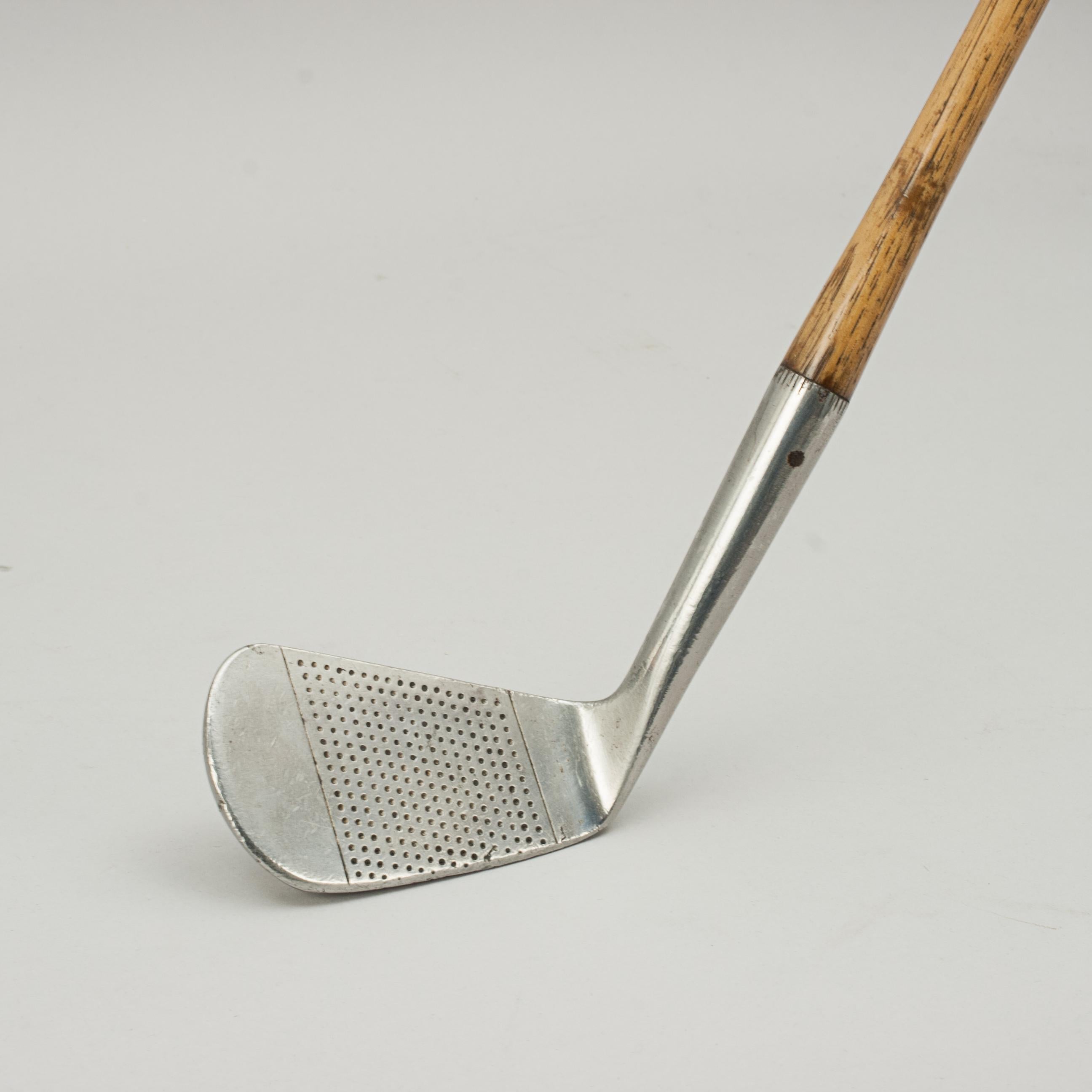 Vintage Hickory Golf Club, George Nicoll, Leven.
A fine and nicely weighted dot punched faced spade mashie by George Nicoll, Leven. The hickory shaft with polished leather grip, the club head is stamped with Nicoll's 'hand' cleek mark, 'Rustless,