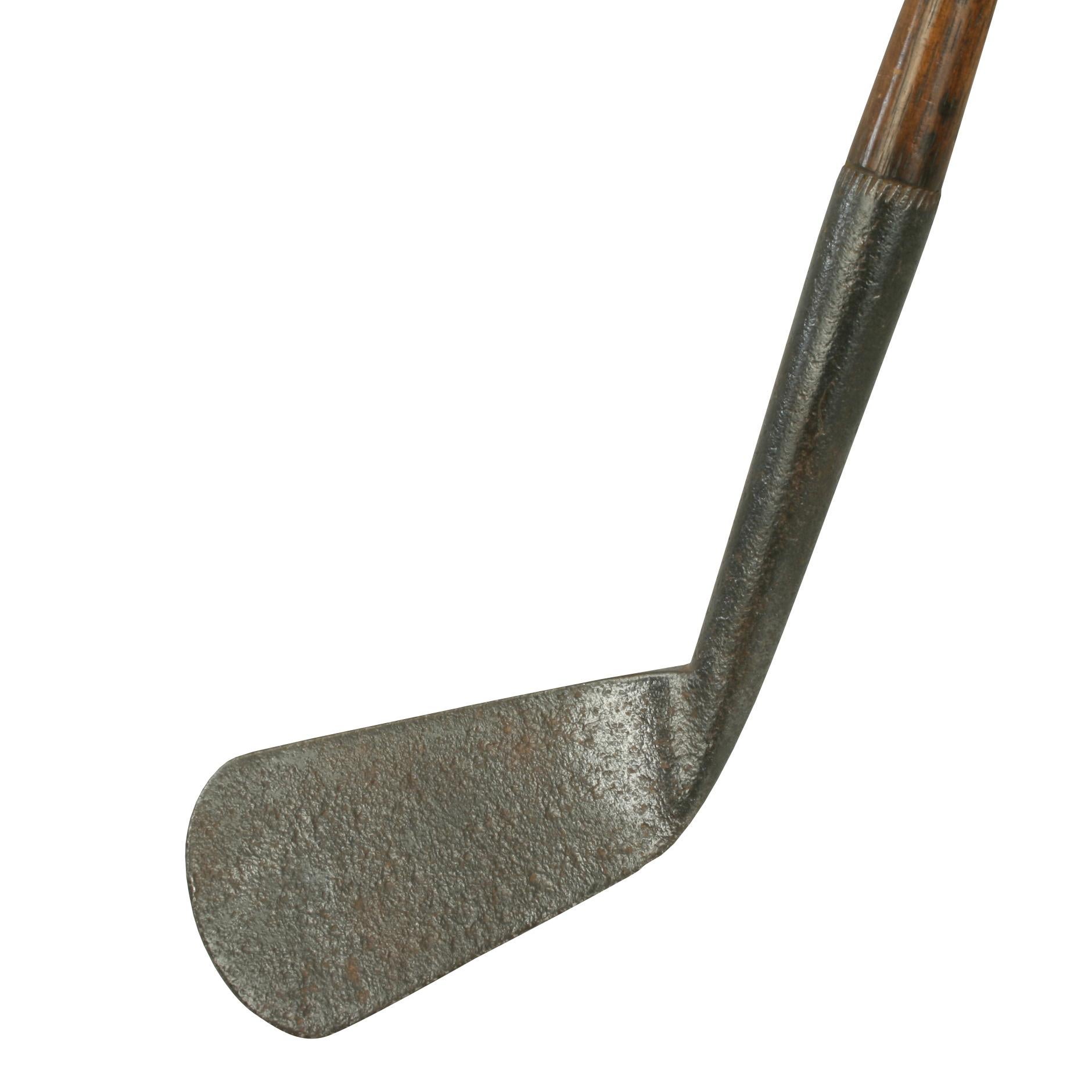 Vintage Hickory Shafted Golf Club, Iron.

An early large head, smooth face golf club, iron. The metal head is pitted but in very acceptable condition. The original hickory shaft with the initials 'AHLM' stamped below an unusual cork grip (intact