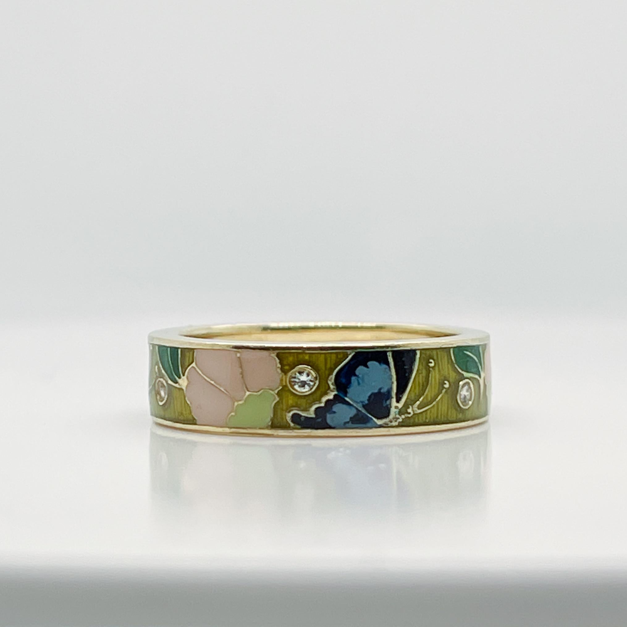 A very fine, vintage Hidalgo 18k gold, diamond and enamel band ring. 

Decorated with brightly colored enamel butterflies and flowers around the circumference and flush-set with round brilliant white diamonds. 

Simply a great ring!

Date:
21st