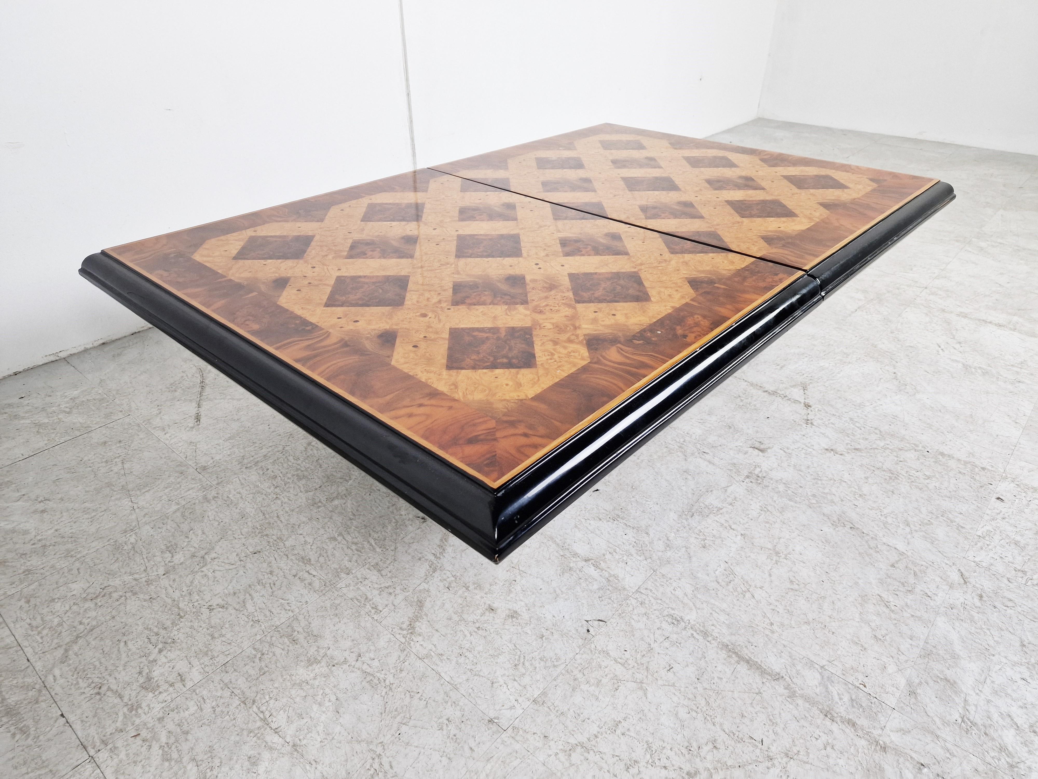 Exquisite wooden coffee table by Eric Maville.

This luxurious coffee table slides open to reveal a storage space for bottles and glasses. 

Attractive veneer wooden top with a beautiful pattern and geometrical design.

Lacquered wooden