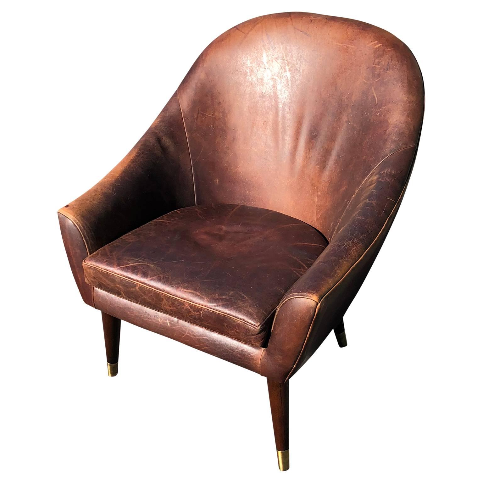 Vintage high back leather club chair with brass caped feet

$125 flat rate front door delivery includes Washington DC metro, Baltimore and Philadelphia.
