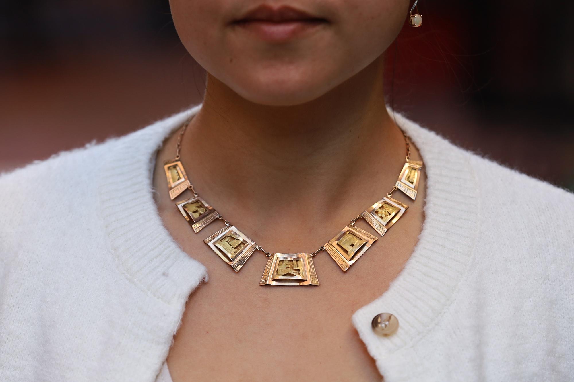 A beautiful and unique discovery, this circa 1950s Peruvian storyteller necklace. It is gorgeously hand crafted of 18k and 20k yellow gold with 7 detailed,  silhouetted stations depicting life in the ancient Mayan culture of Peru. A musician, a