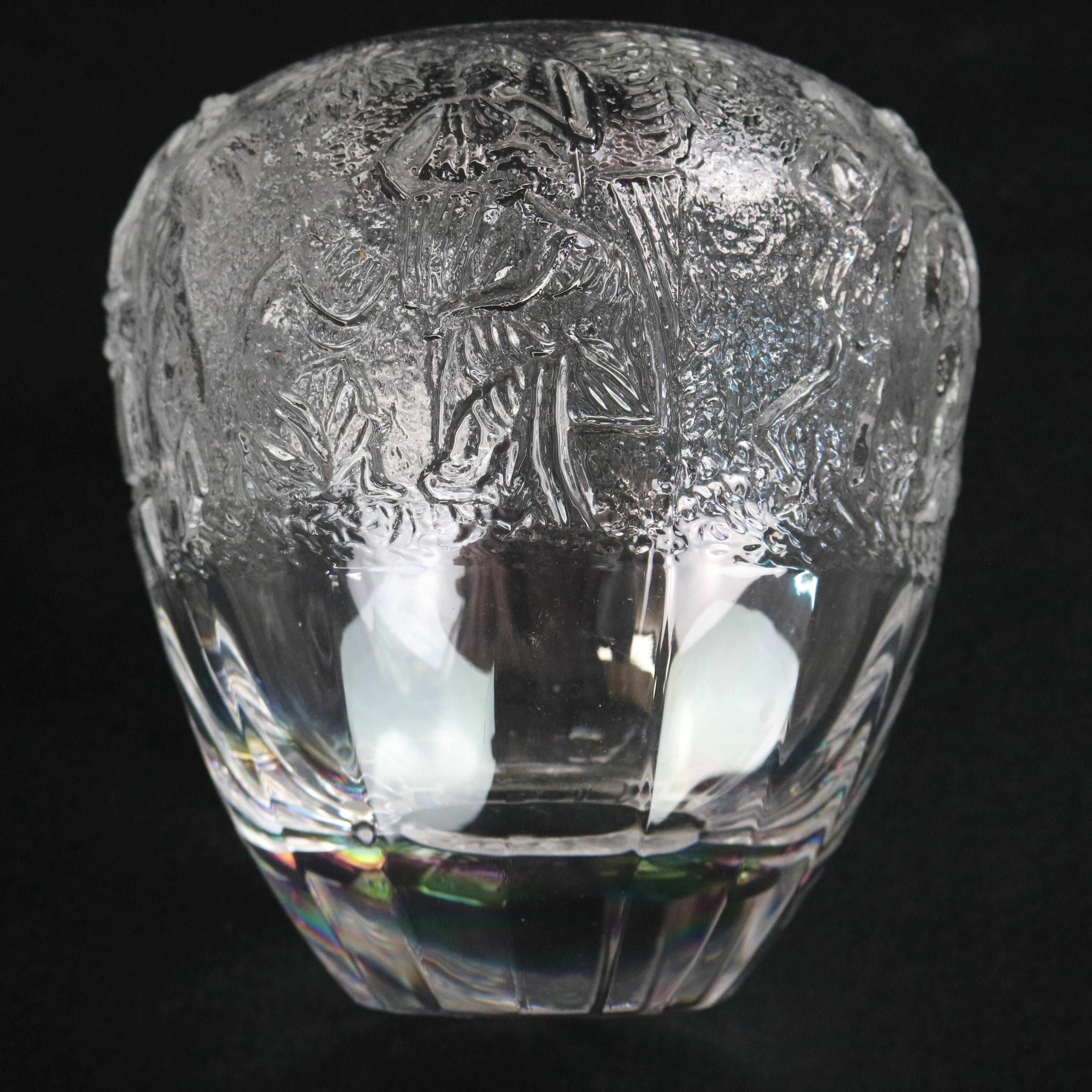 A vintage art glass vase offers bulbous form with upper having high relief scene with figures and garden elements, circa 1950.

Measures: 7.5