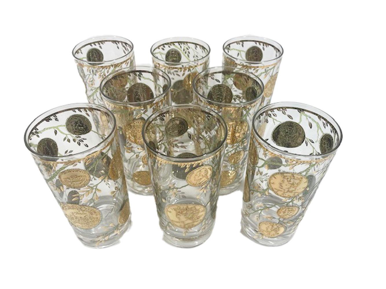 Eight vintage highball glasses by Culver, LTD. in the gold version of the 'Midas' pattern. Decorated with 22 karat gold American coins (obverse and reverse) on branches of raised translucent green enamel with gold leaves.