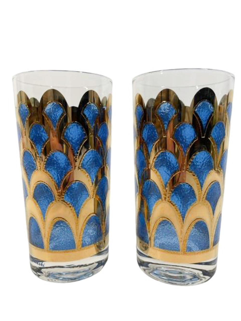 Set of six mid-century modern highball glasses designed by Irene Pasinski for Washington Glass. Decorated in deep blue translucent enamel framed in wide arches of raised 22k gold forming a fish scale like pattern.