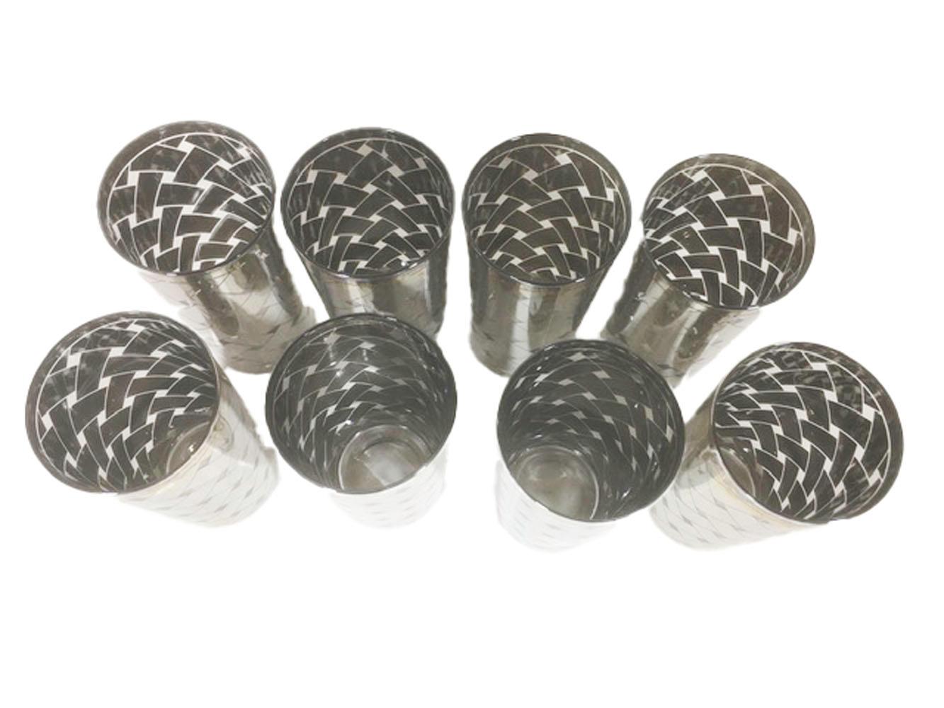 Mid-Century Modern highball glasses with an allover basket weave pattern in silver. The design is made up of wide bars of silver with openings in between giving the illusion of an open weave.