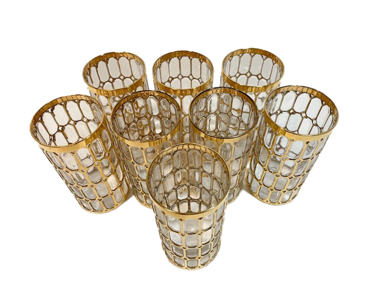 Set of 8 Mid-Century Modern highball glasses in the Spanish Windows pattern. Molded with raised design covered in 22 karat gold.