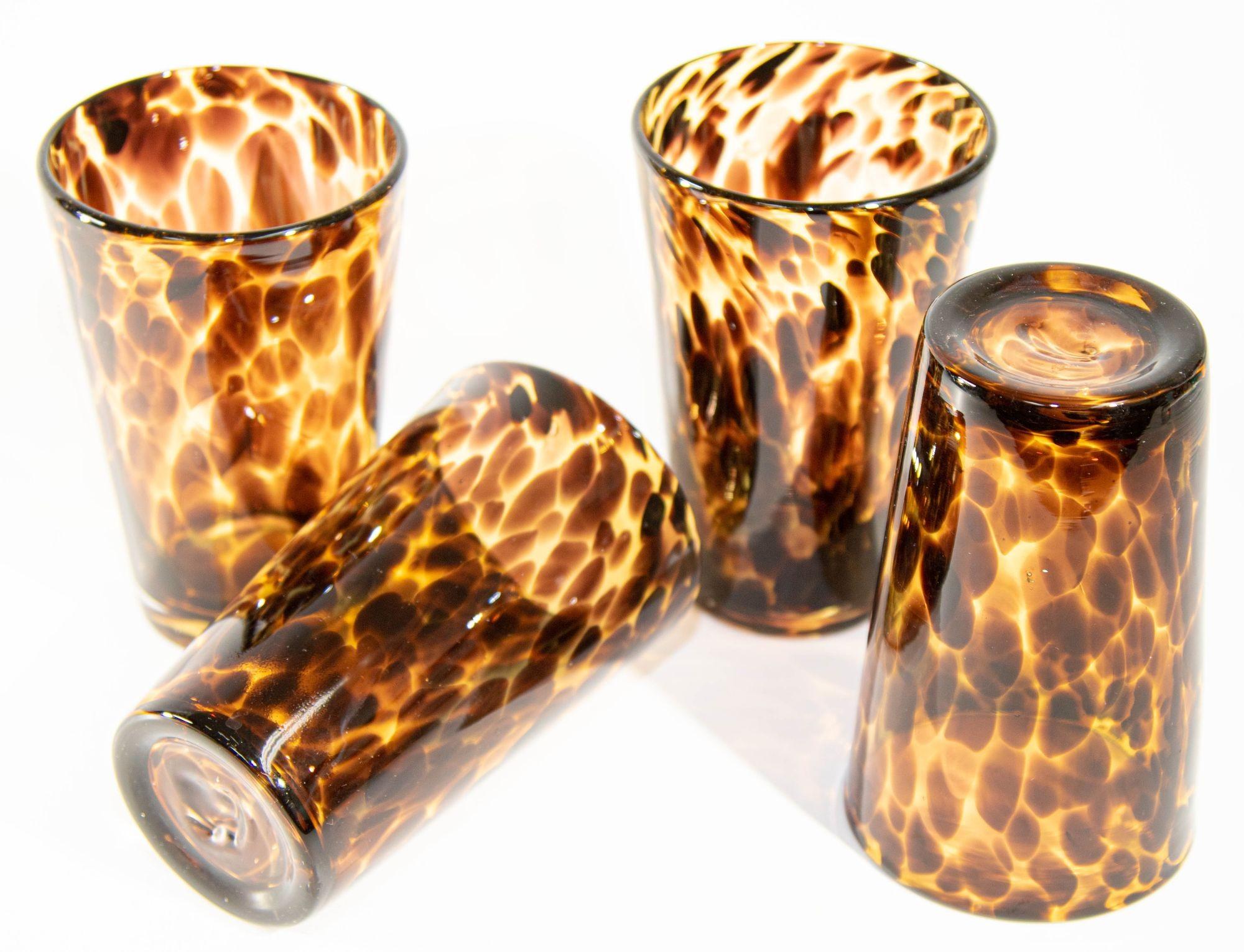 Vintage amber drinking glasses set of four highball tumbler glasses mouth-blown with exclusive tortoiseshell color flowing pattern.
A distinctive tortoise shell motif brings rich color and dimension to a glass barware set that makes a stunning