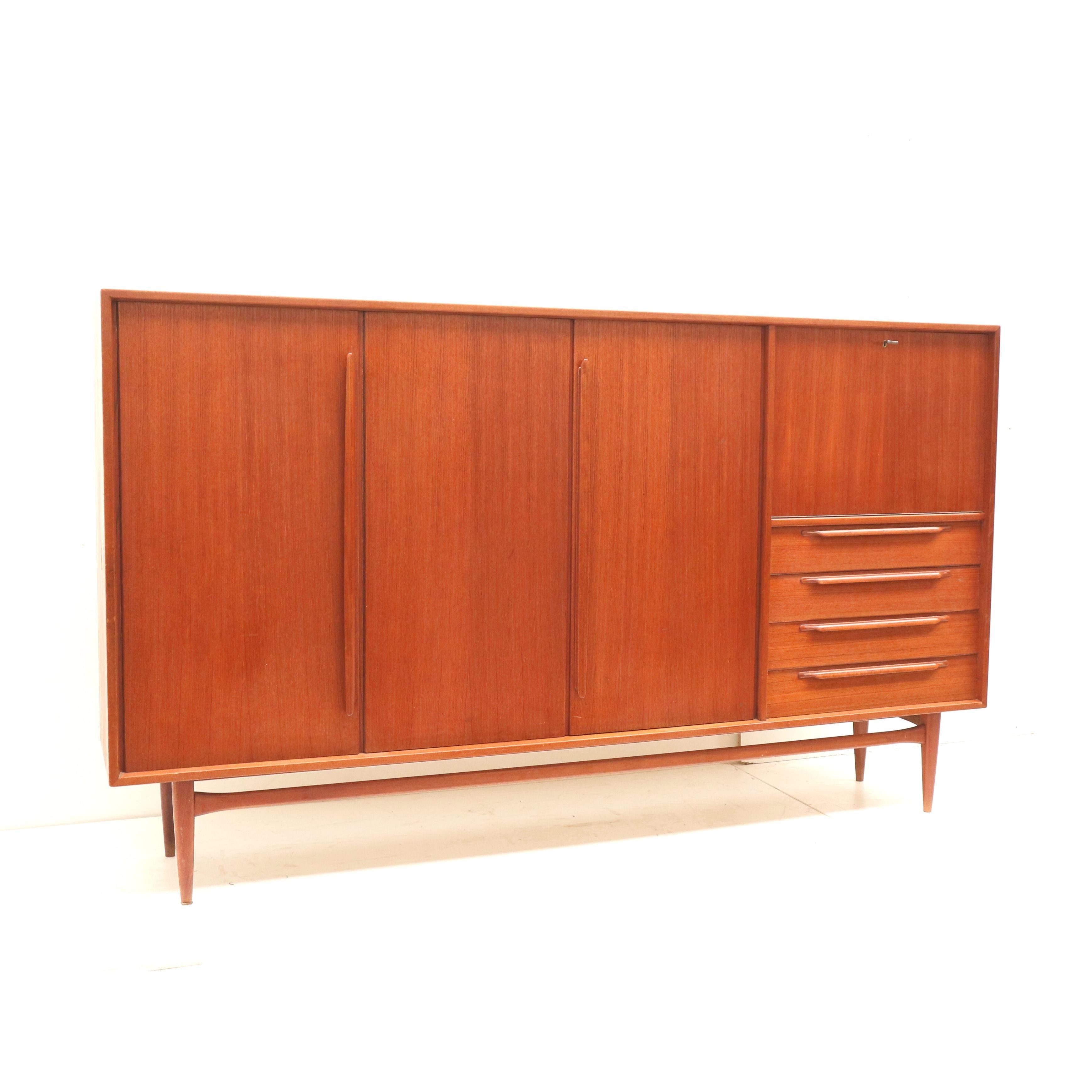 Vintage highboard / sideboard by Heinrich Riestenpatt made in the 60s.

Dimensions:
Width: 240 cm
Depth: 44.2 cm
Height: 140 cm

The highboard has some traces of use on the inside and outside appropriate to its age.