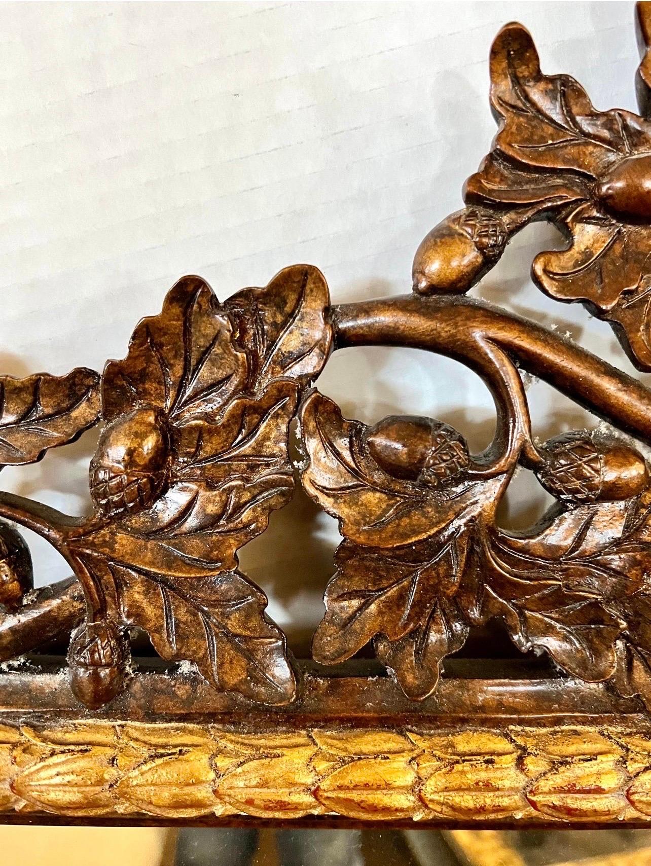 Highly carved ornate wood windows mirror with carved motif of oak leaves and acorns with beautiful giltwood accents. Features beveled glass. Signed on back with LaBarge label. Why not own the best?