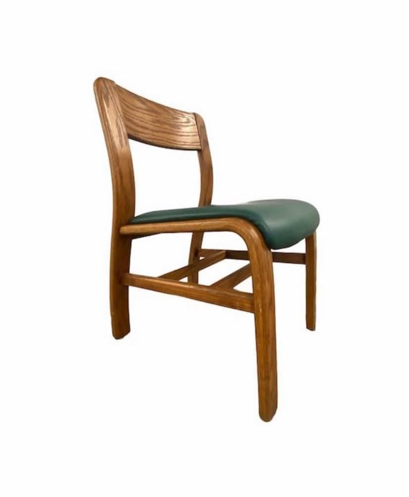 Beautiful Hill-Rom dining chairs made of oak with a green faux leather upholstery for the seat. Hill-Rom is known for making the most unique furniture with comfortability and care in mind. Price displayed of Chairs are for the set of 6 not