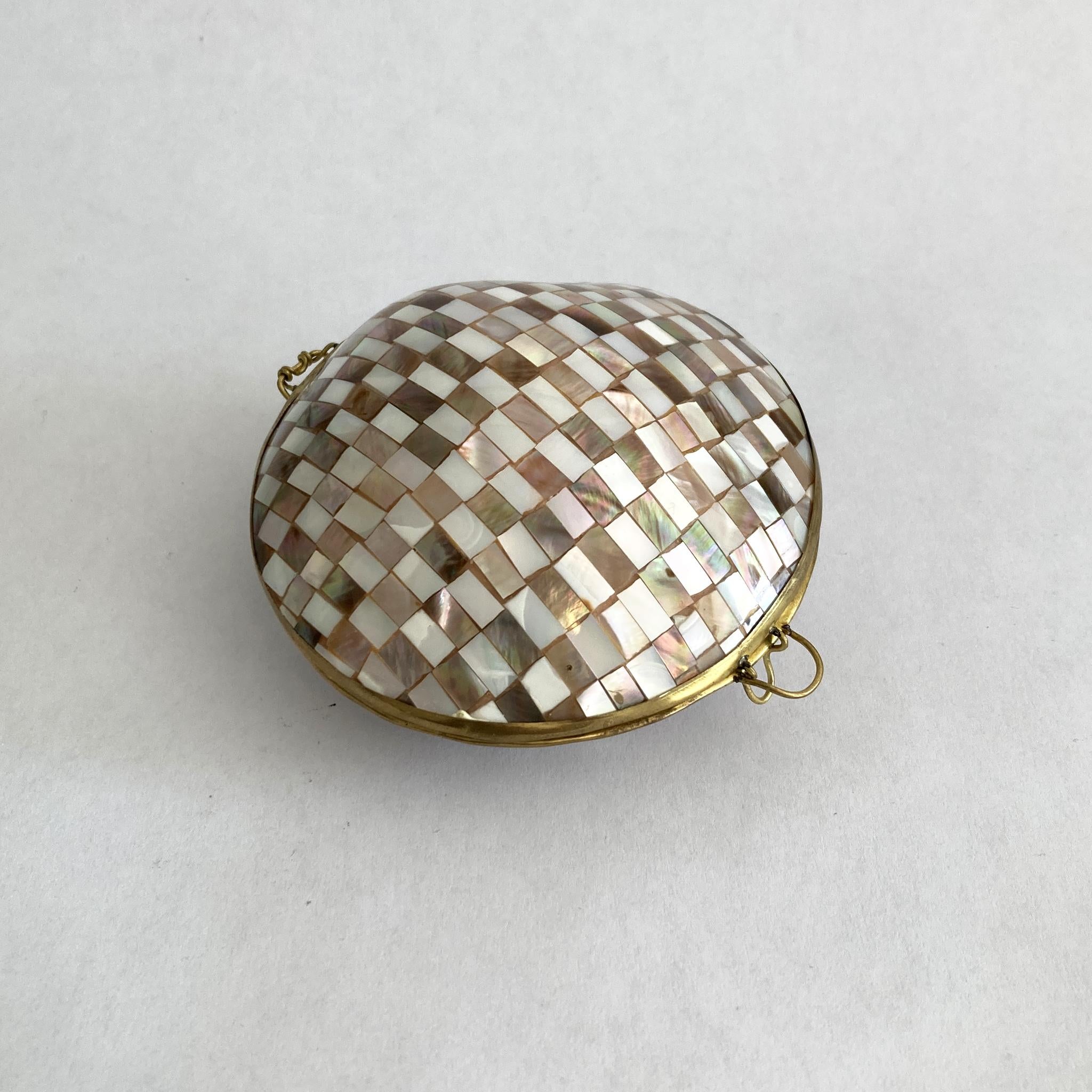 Beautiful, unique petite hinged shell box. This is a real shell covered in mother of pearl and made into a hinged box, charming. The checkerboard pattern of the mosaic contrasts beautifully with the brass hardware. This piece looks great as part of