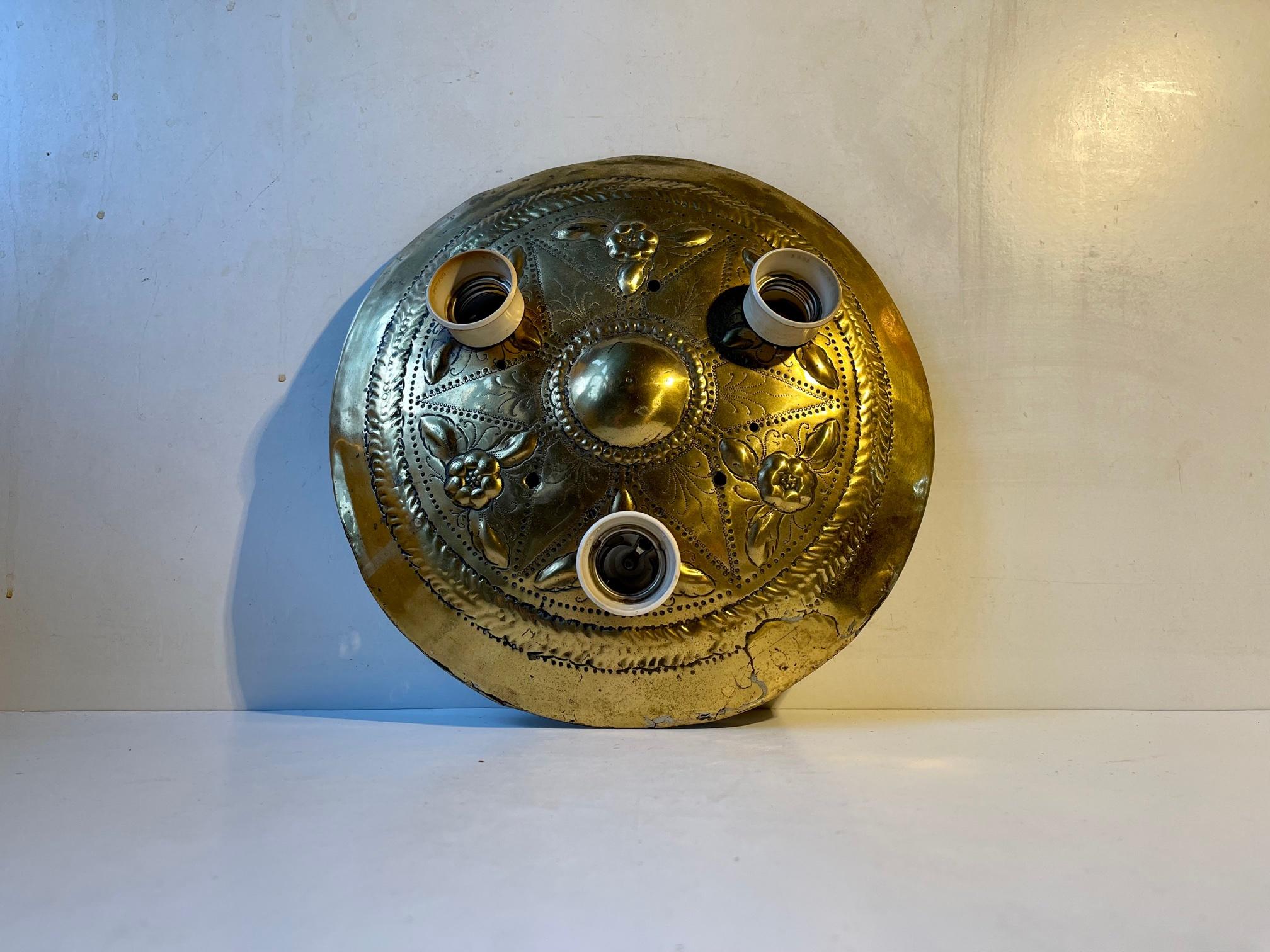 It does not get much sustainable than this; vintage, hippie and repurposed. Antique embossed brass wall shield built into a lamp with 3 lightsources. It can be installed as either a wall or ceiling fixture. It was Custom/Hippie made in Denmark