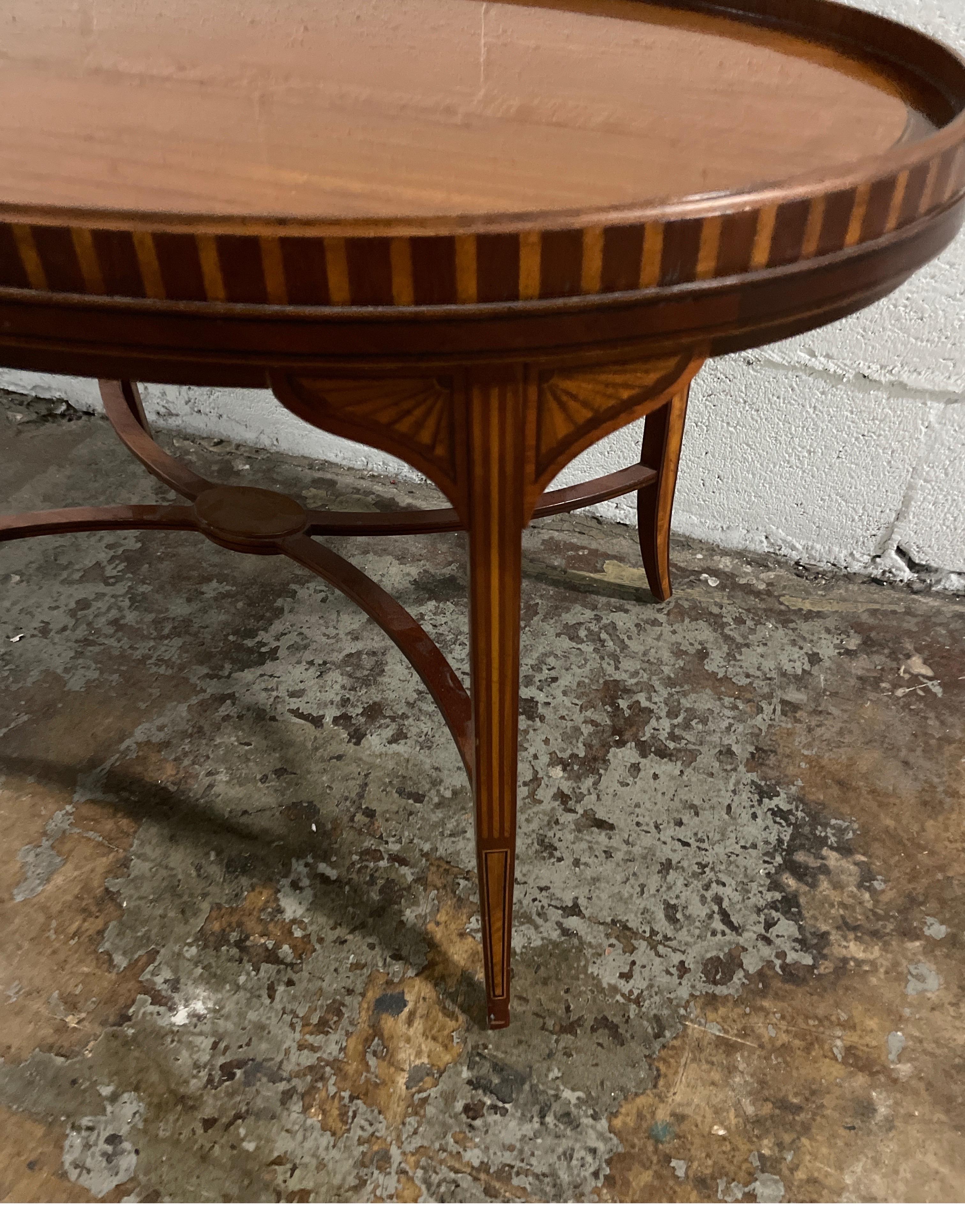 Handsome Butler's style coffee or tea table made by Baker for their Historical Charleston Collection. Made of mahogany and satinwood with brass handles. A beautiful addition to any room. Great attention to detail.