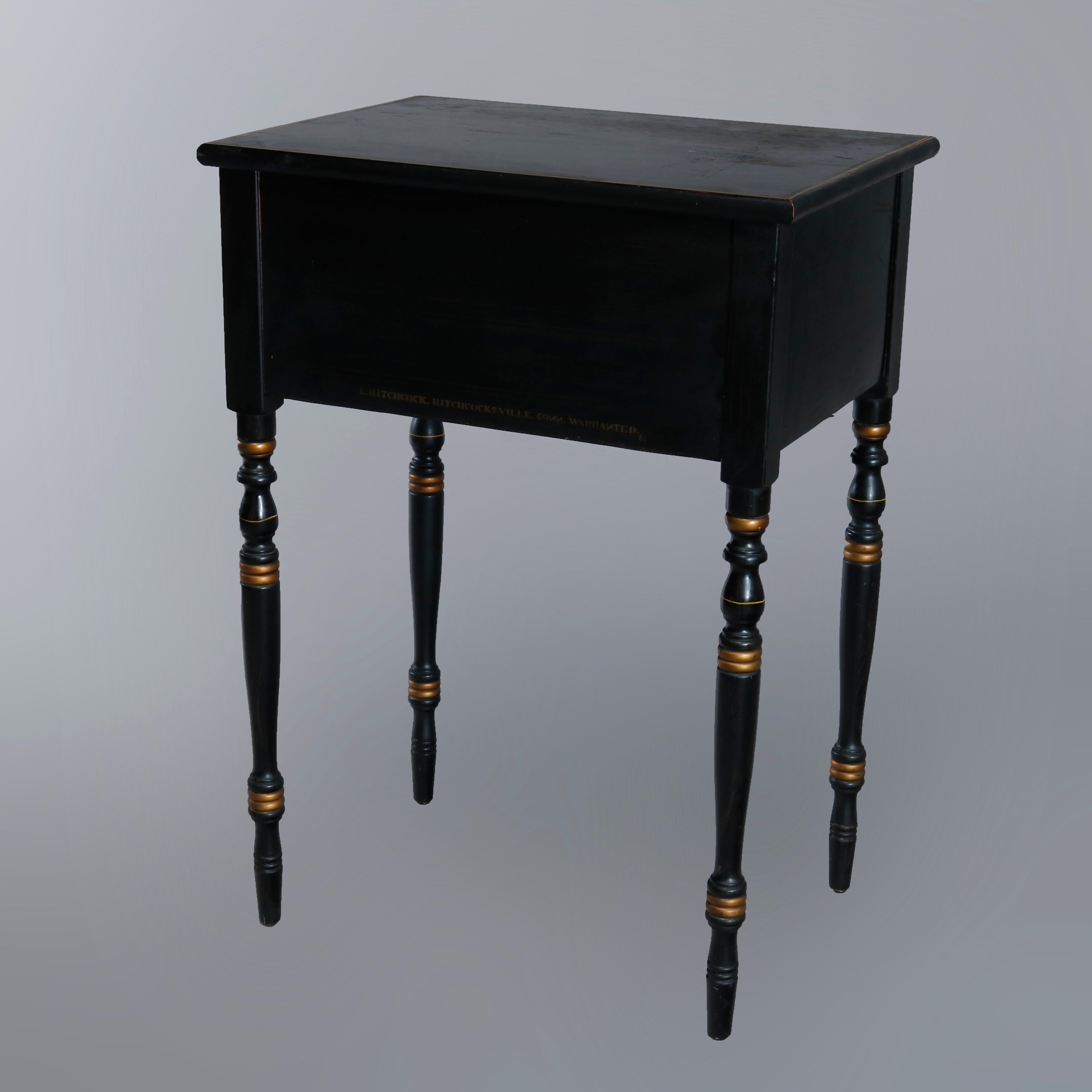 A vintage side stand by Hitchcock offers ebonized wood construction with case having two paint decorated drawers and raised on turned legs, en verso signed as photographed, circa 1950

Measures: 29.25