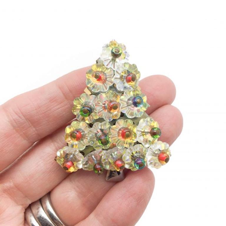 A Vintage Hobe Christmas Tree Brooch dating to 1965. Fun and glamourous for Christmas time. Featuring embellished gold plated metal set with numerous tightly packed rainbow rivoli crystals with exceptional pin head beading. Signed Hobe 1965,