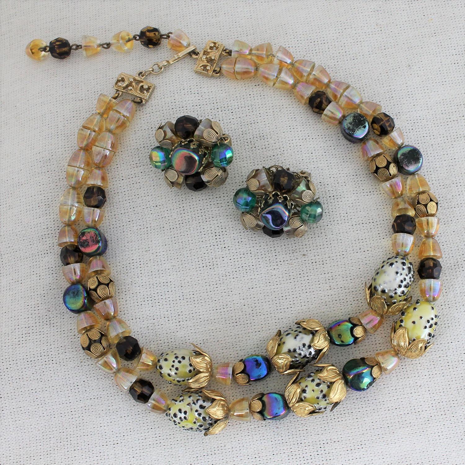 Phenomenal and stunning vintage Hobé crystal necklace and earrings set. Double stranded glass and crystal beads with gold-tone filigree accent. In excellent vintage condition with all original beads.

Striking and impossible to miss! This vintage