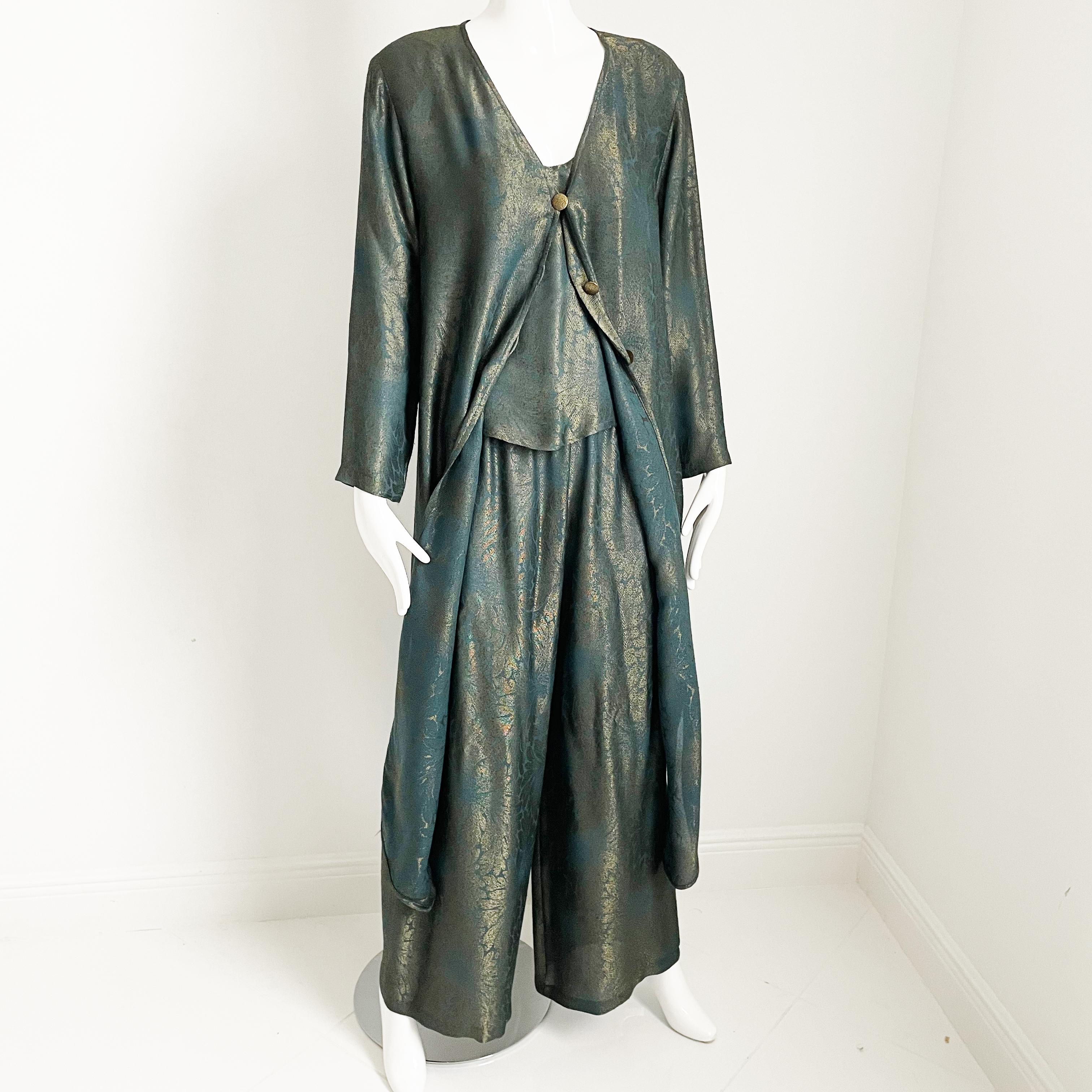 Authentic, preowned, vintage 80s Holly's Harp Pantsuit 3pc Set Long Duster Jacket, Top & Pants, tagged M.  Sold by Saks Fifth Avenue.  Long jacket features side vents with gold metal buttons; pants fasten with zip in back. Synthetic fabric in teal