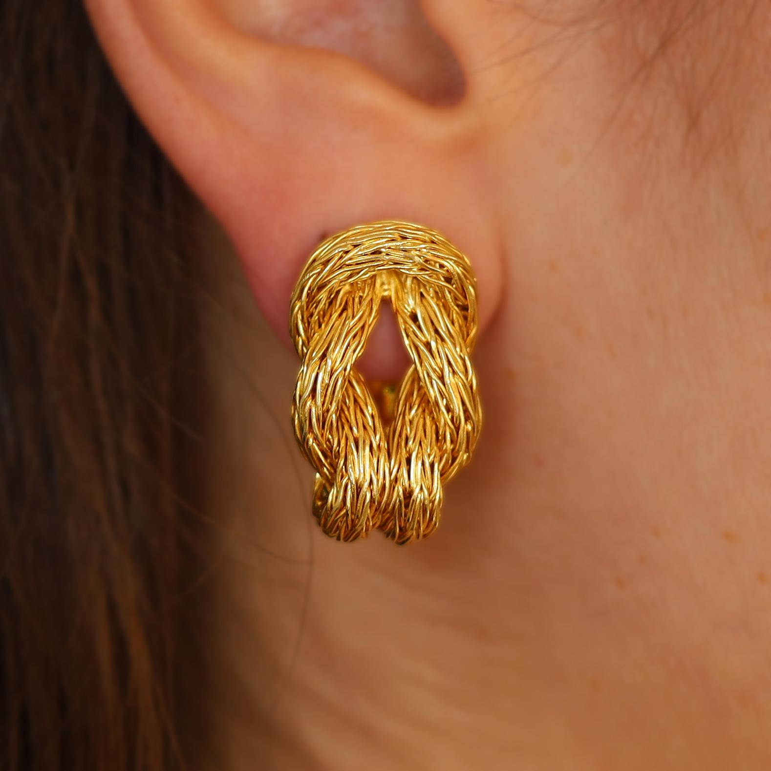 An elegant statement of eminently wearable earrings. Fabricated of rich high karat 18k gold, the woven Byzantine rope is braided into a timeless Hercules knot. Vintage 1970s with a timeless design, these heirloom ear clips are completed by