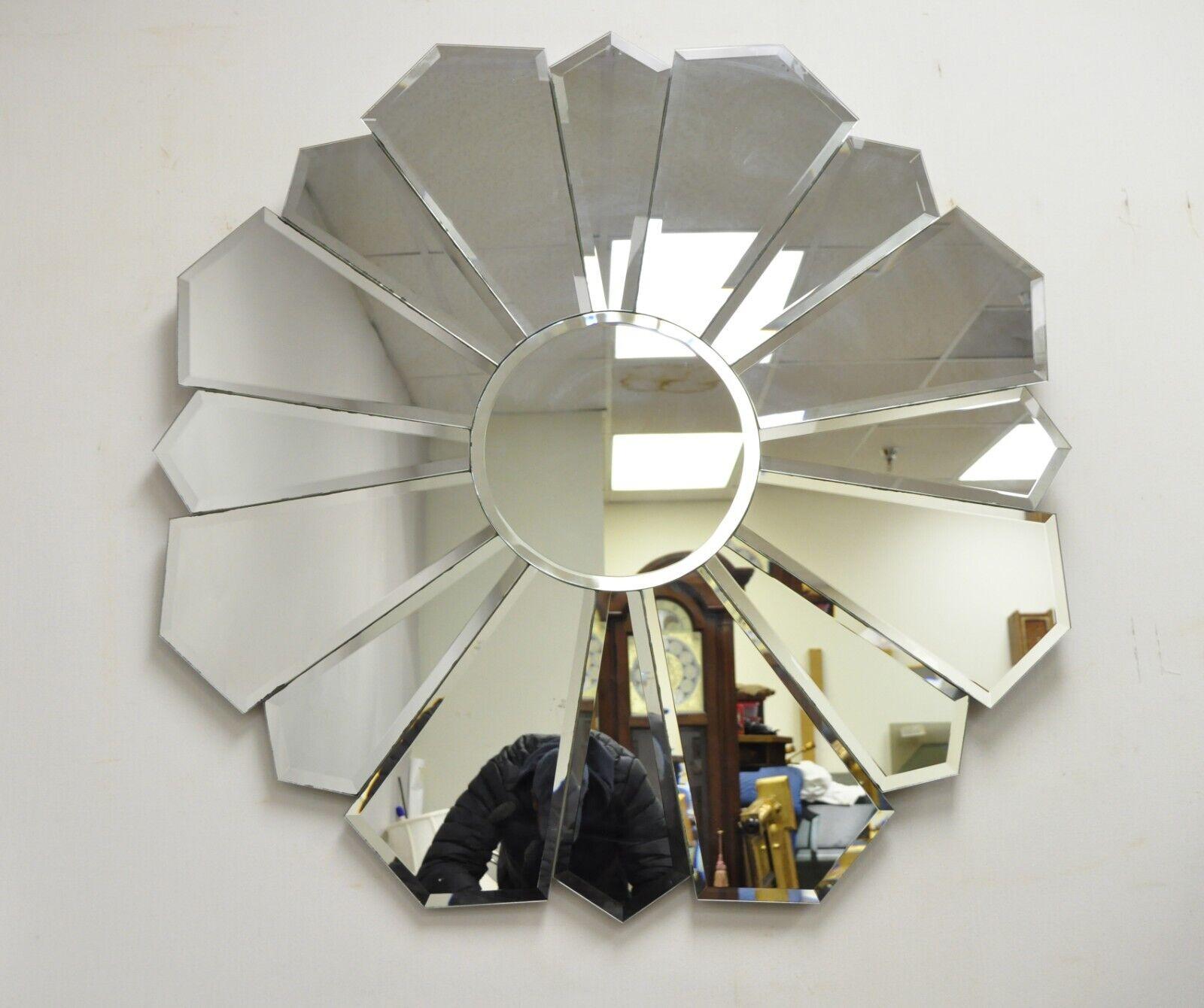 Vintage Hollywood Regency beveled glass sunburst flower petal wall mirror. Item features a unique sunburst/flower petal design, clear beveled glass panels, very nice item, great style and form. Circa late 20th century. Measurements: 38.5