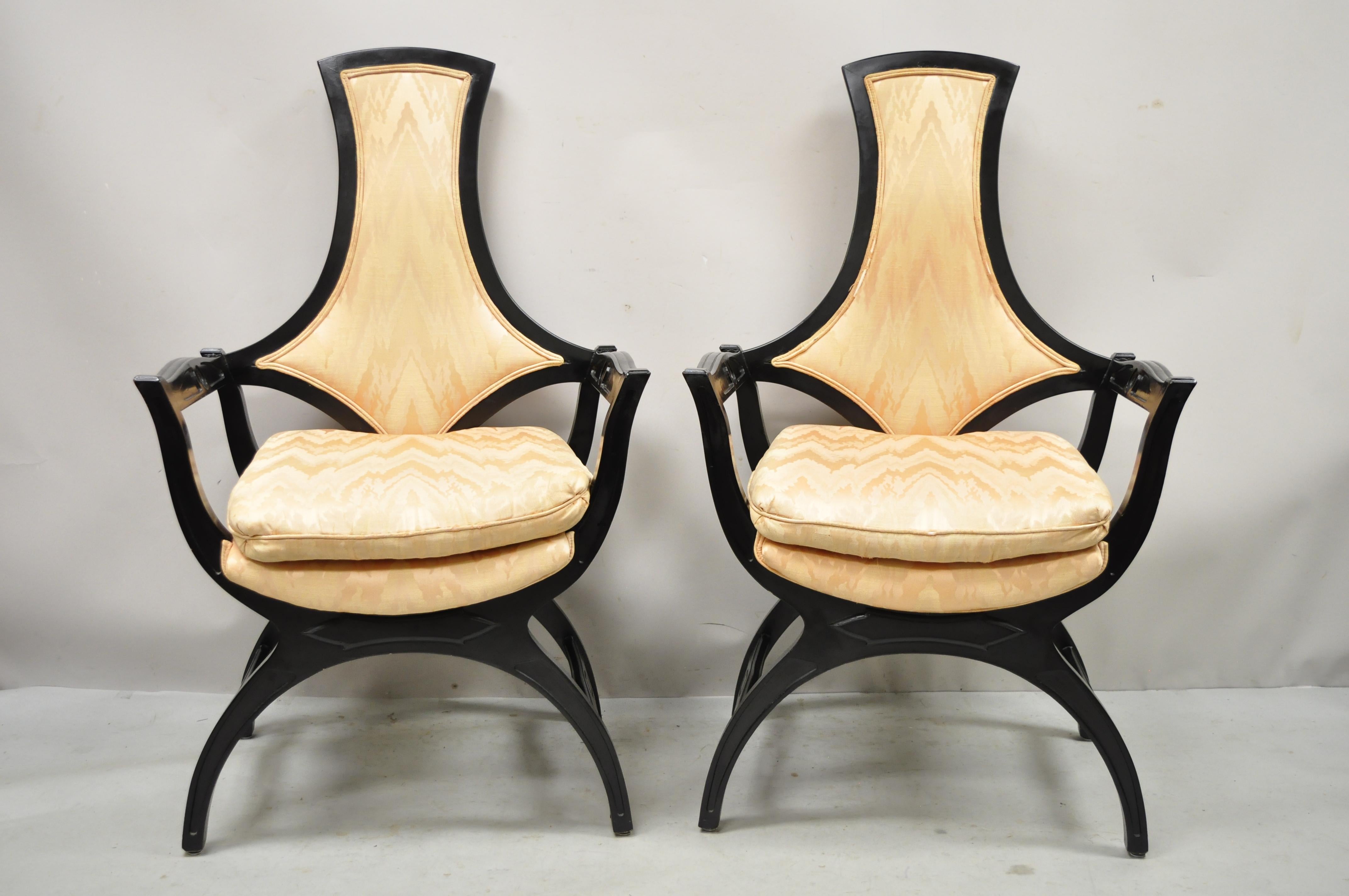 Vintage Hollywood Regency black Curule frame upholstered lounge arm chairs- pair. Item features black finish, curule form base, shaped backrest, solid wood frames, very nice vintage pair, great style and form. Circa mid 20th century. Measurements: