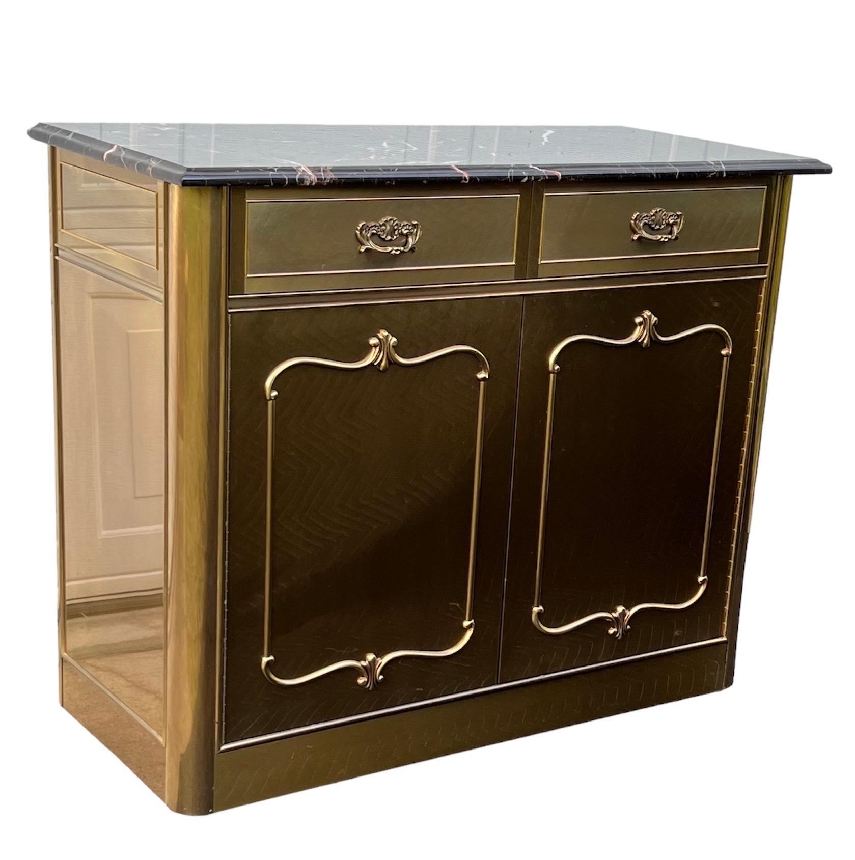 Absolutely gorgeous brass bar cart or small buffet, 2 doors with a single adjustable shelf inside,interior is painted in gold. 
2 drawers above the doors with wood interiors in perfect clean condition 
A very convenient removable marble top,that