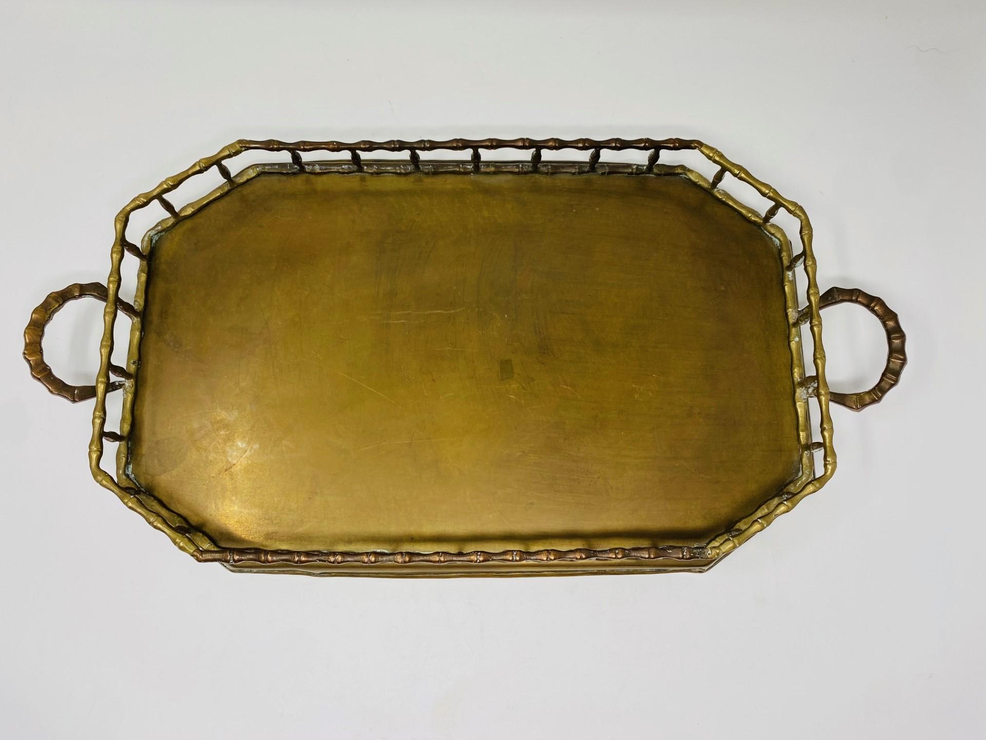 Beautifully luxurious and incredibly glamourous brass serving tray. This serving tray in a faux bamboo design brings Hollywood presence to your décor. The faux bamboo design is sculptural and wraps around the octagonal piece including in the