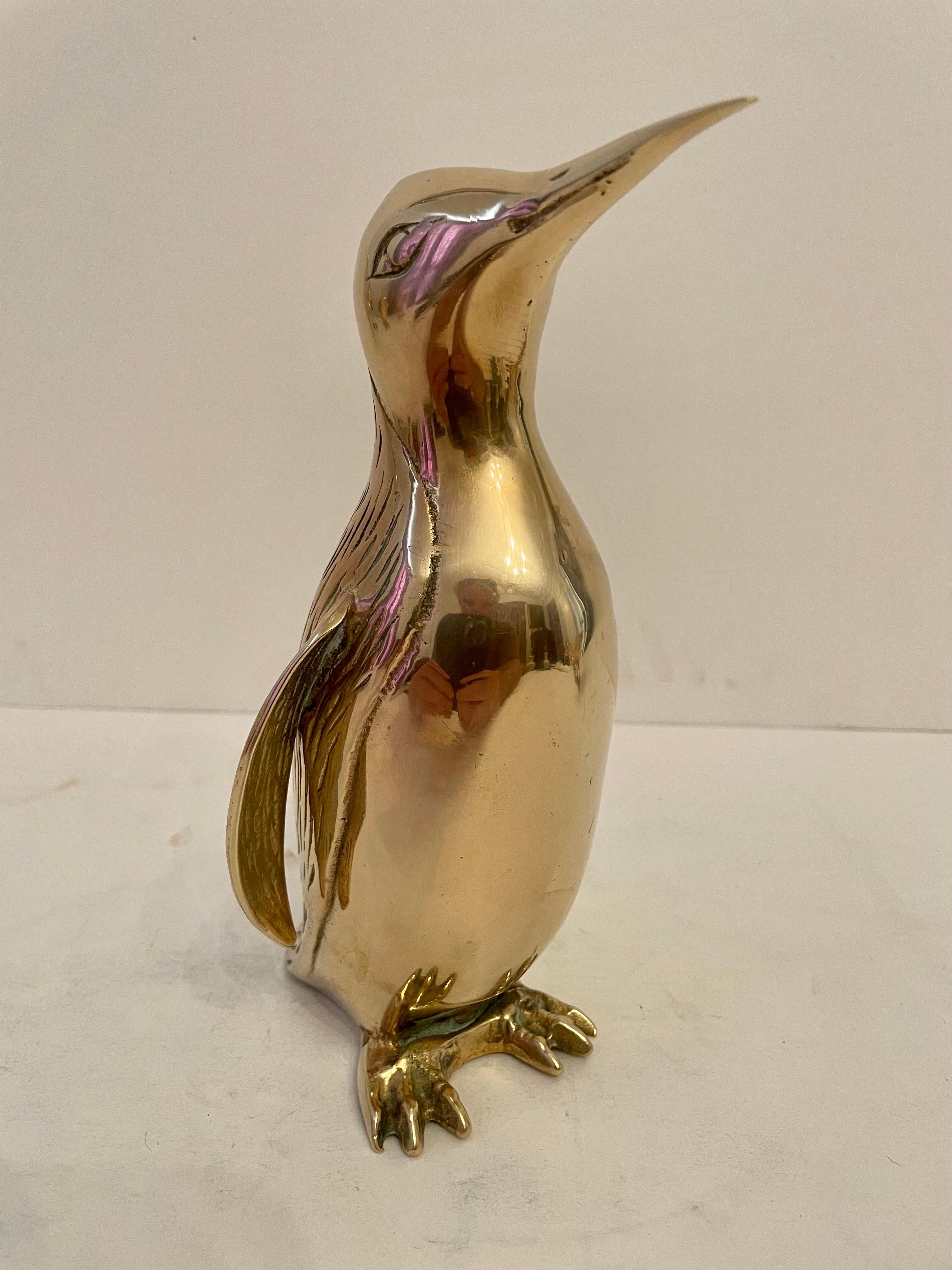 Vintage Hollywood Regency brass Penguin sculpture. Nicely detailed. Hand polished. Good overall condition. Dark spots are reflection of light in photos. Measures 8” tall x 4” wide x 4.25” deep.