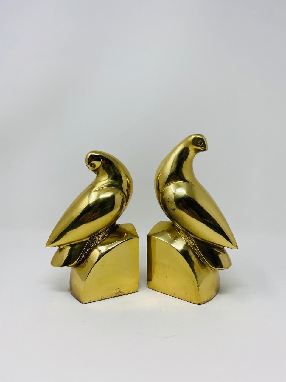 Beautiful pair of Hollywood Regency style bookends. This weighted pair sculpted from brass, brings charm and glamour at the same time. Sculptural and gilded, they will bring light and beauty to your décor. The beauty and design of these bookends can