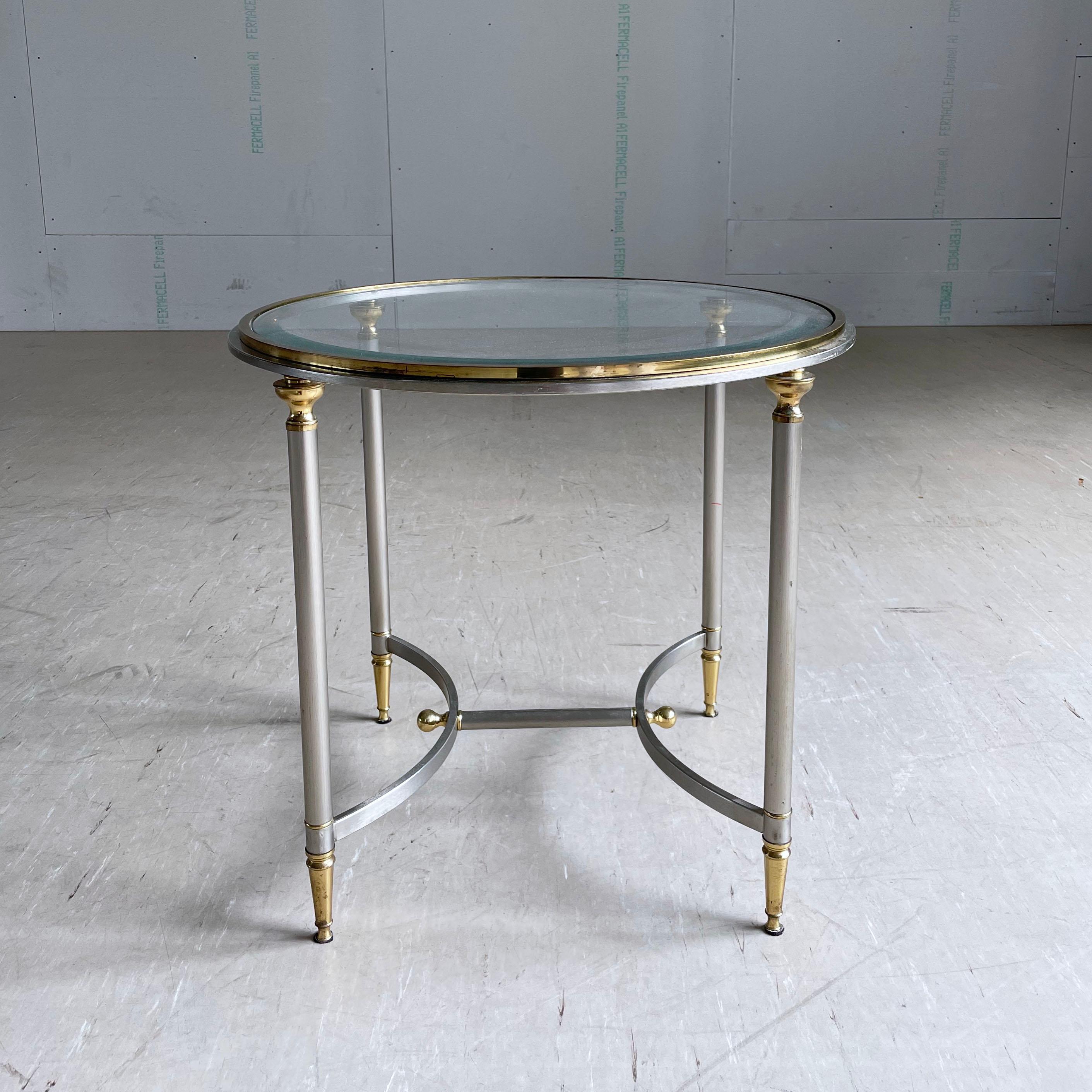 Vintage Hollywood Regency brushed steel & brass side table with glass plate. In the style of Maison Jansen. Originates from Hotel Jungfrau, Interlaken, Switzerland.