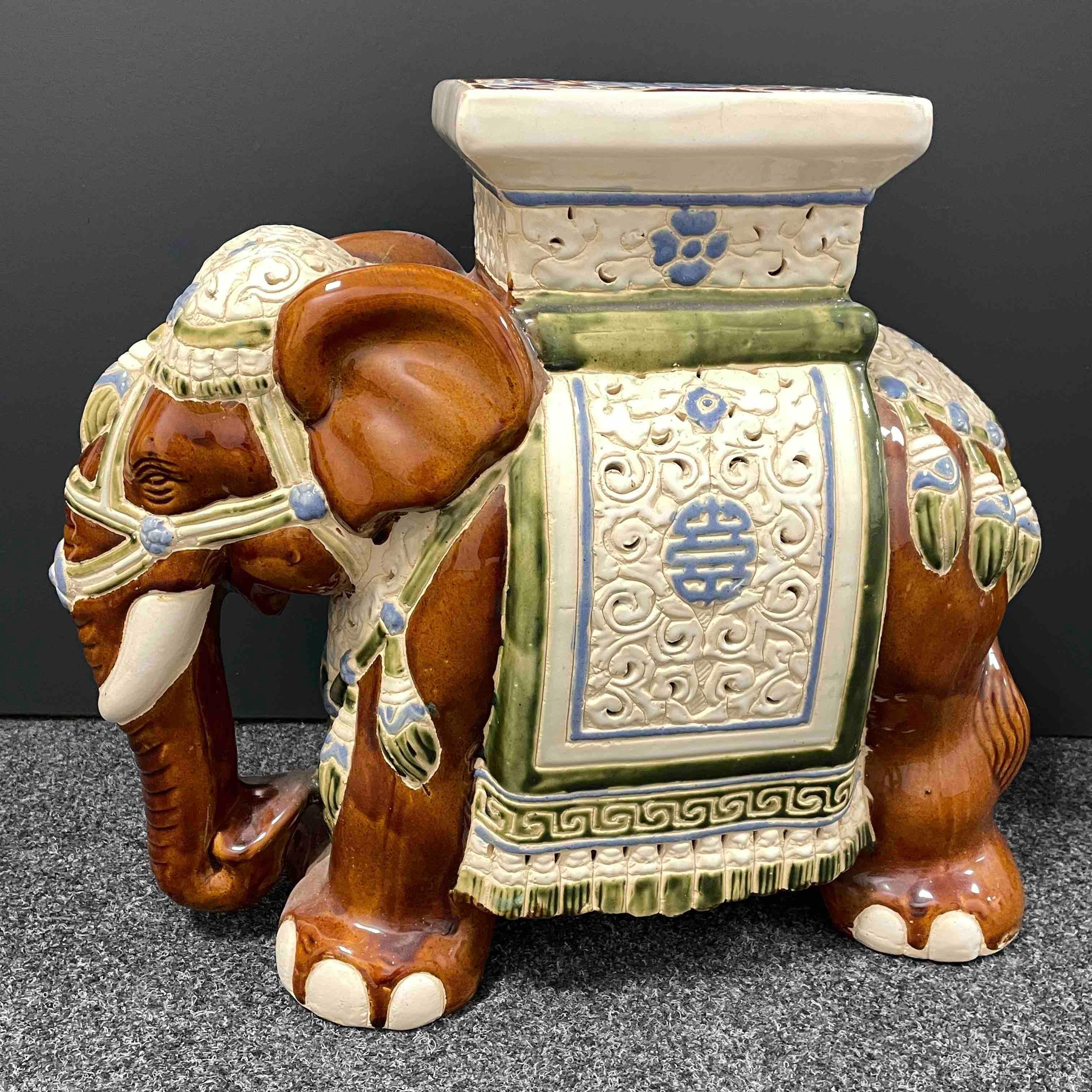 Mid-20th century glazed ceramic elephant garden stool, flower pot seat or side table. Handmade of ceramic. Nice addition to your home, patio or garden. Also nice in your pool area to hold your personal belongings.
 