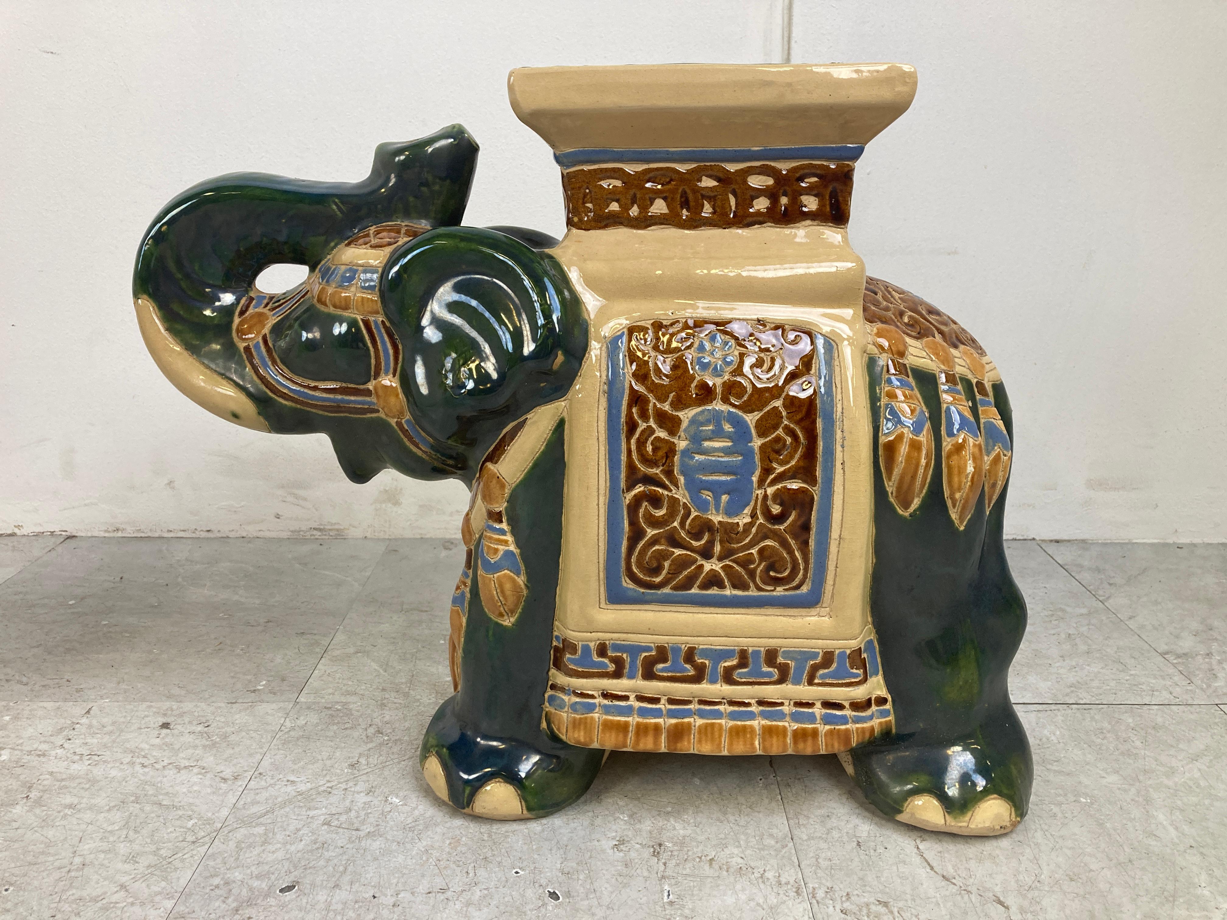 Very decorative midcentury chinoiserie glazed ceramic elephant plant stands.

Can also be used as little side tables or just decor.

Beautifully coloured ceramic sculptures which look great as a pair.

1960s - Italy

Very good