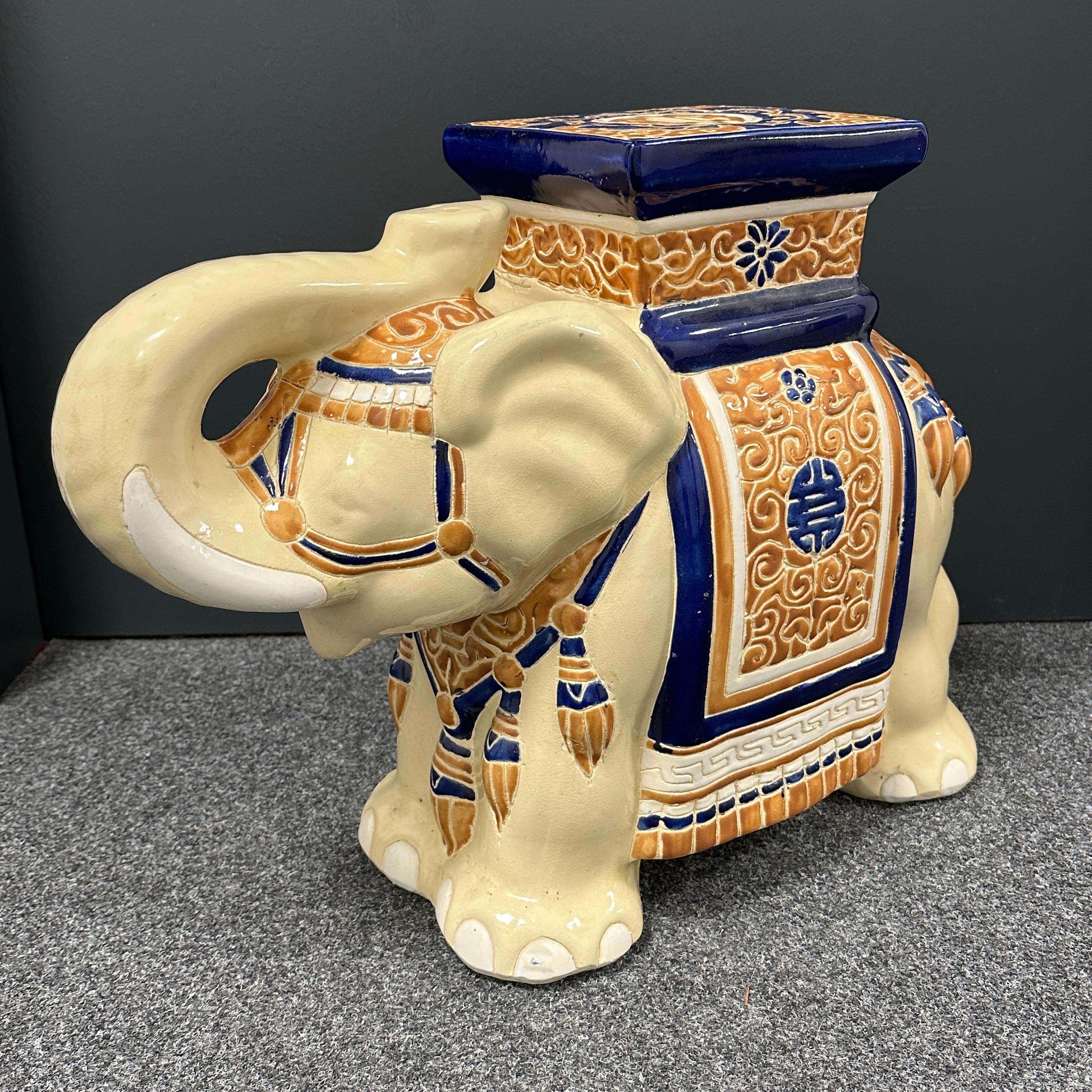 Mid-20th century glazed ceramic elephant garden stool, flower pot seat or side table. Handmade of ceramic. Nice addition to your home, patio or garden. Also nice in your pool area to hold your personal belongings or as a drinks stand.
  