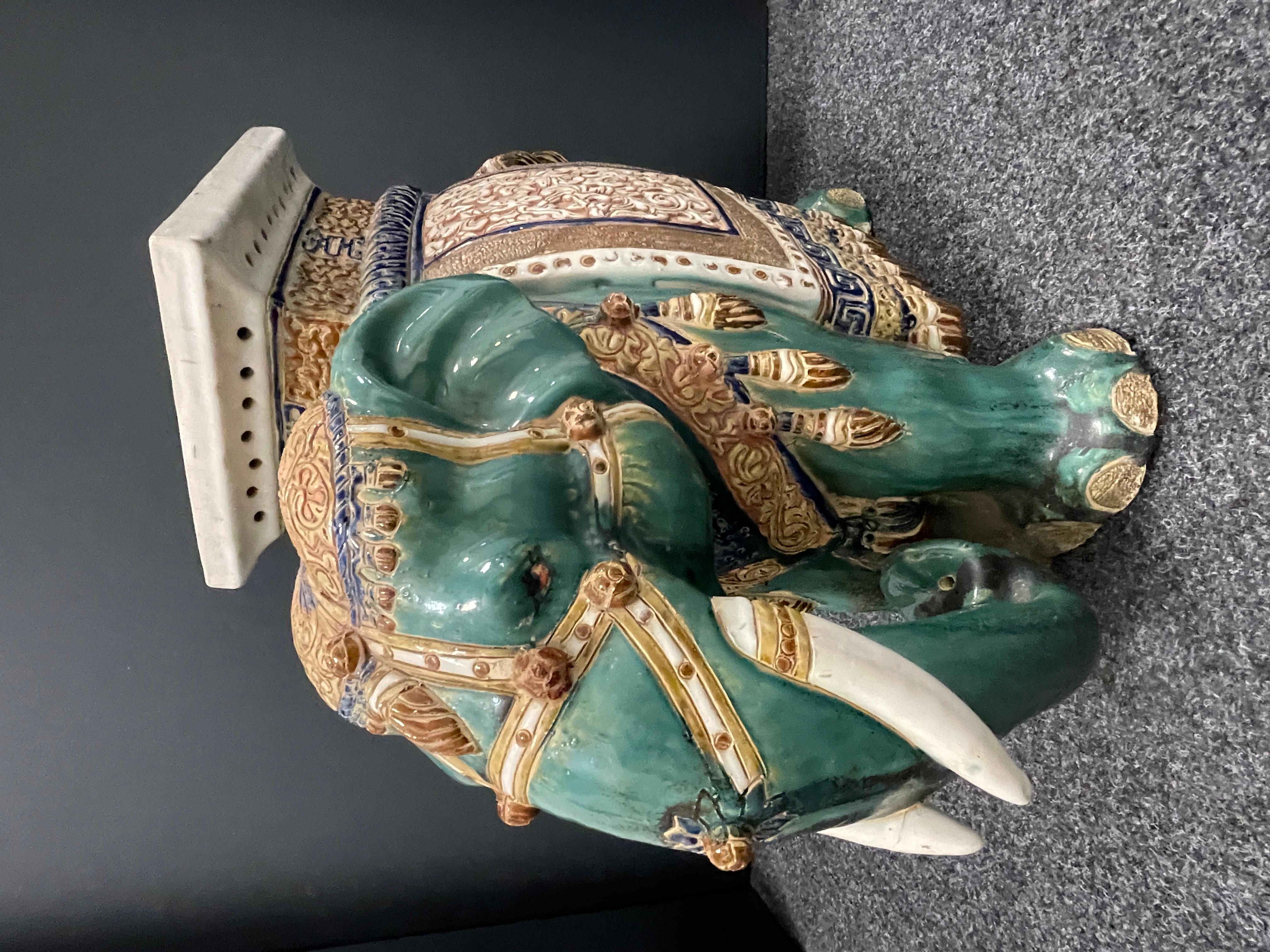 green ceramic elephant plant stand
