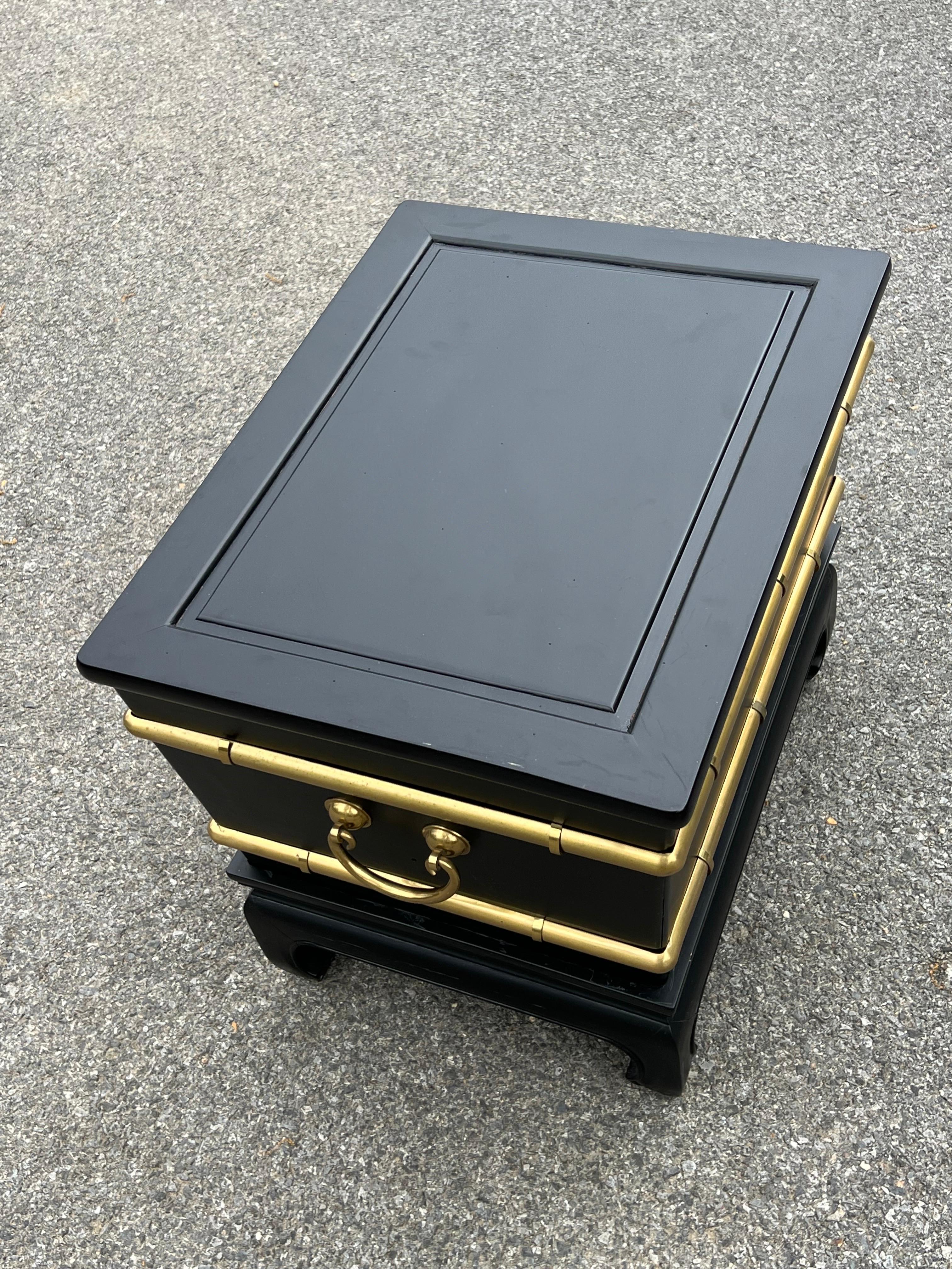 Very unique black ebonized with faux bamboo brass accents side table, single drawer on the side, looks like a chest but top doesn’t open. The base is separate and has beautiful Ming style legs. 
Great Size to be used also as small coffee table.