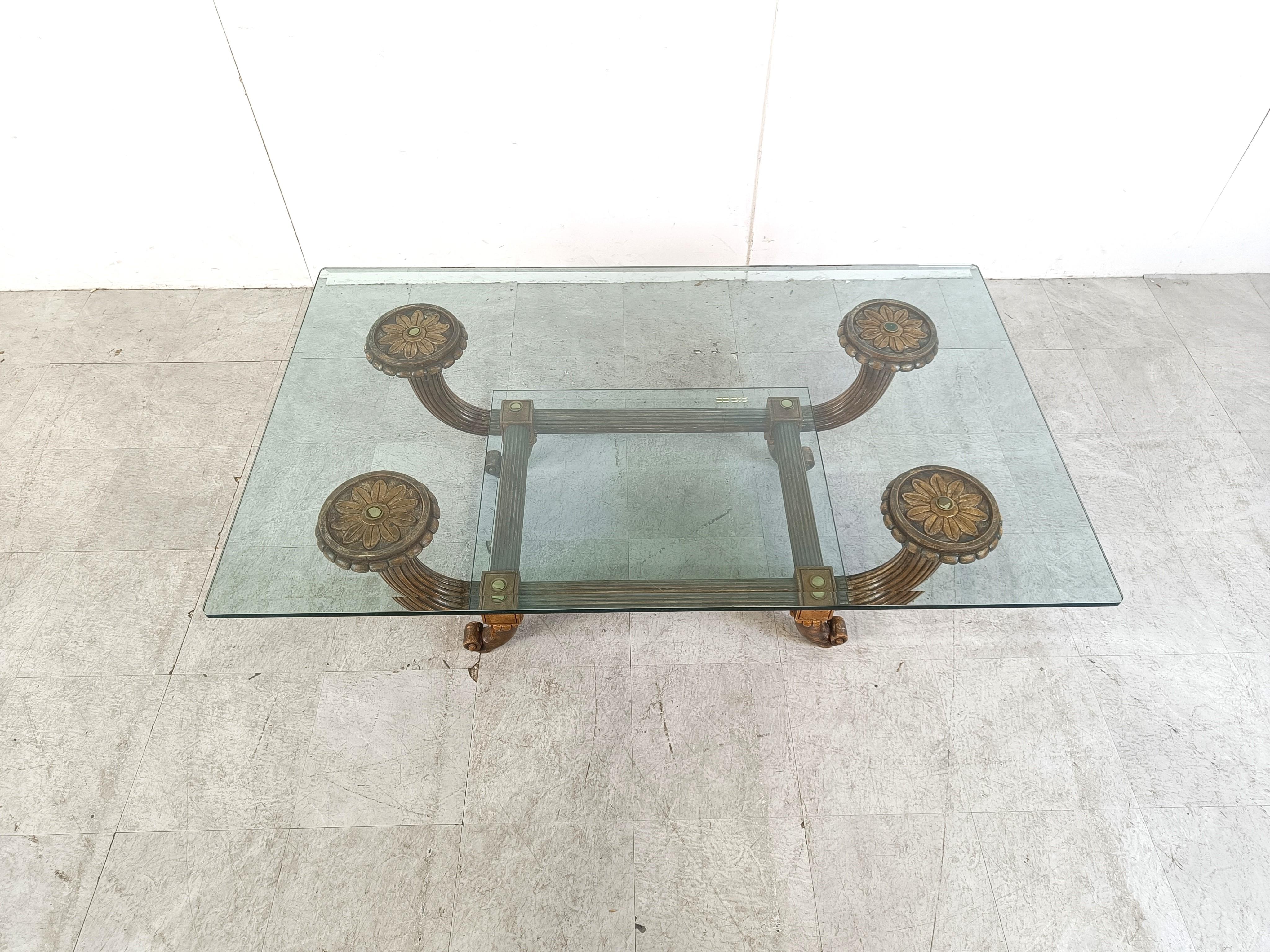 Mid century sculptural wooden coffee table in hollywood regency style. 

Resembles a lot the style of Vidal Grau.

Beautiful curled legs, beautiful reeded bentwooden arms supporting a clear glass top.

Stately coffee table with a luxurious appeal.